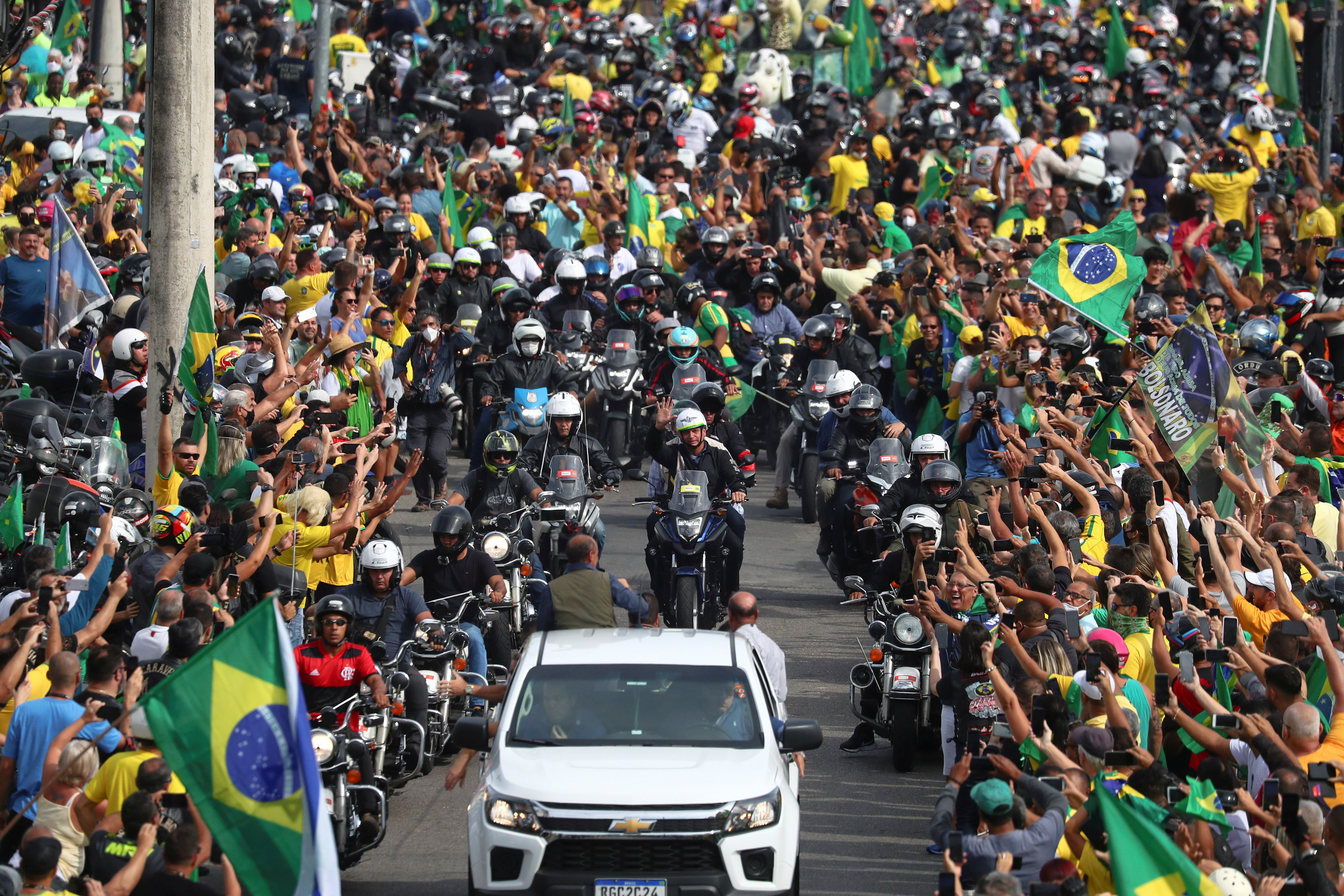 Brazilian President Jair Bolsonaro, centre, joined thousands of his supporters in a motorcycle rally through Rio de Janeiro on Sunday