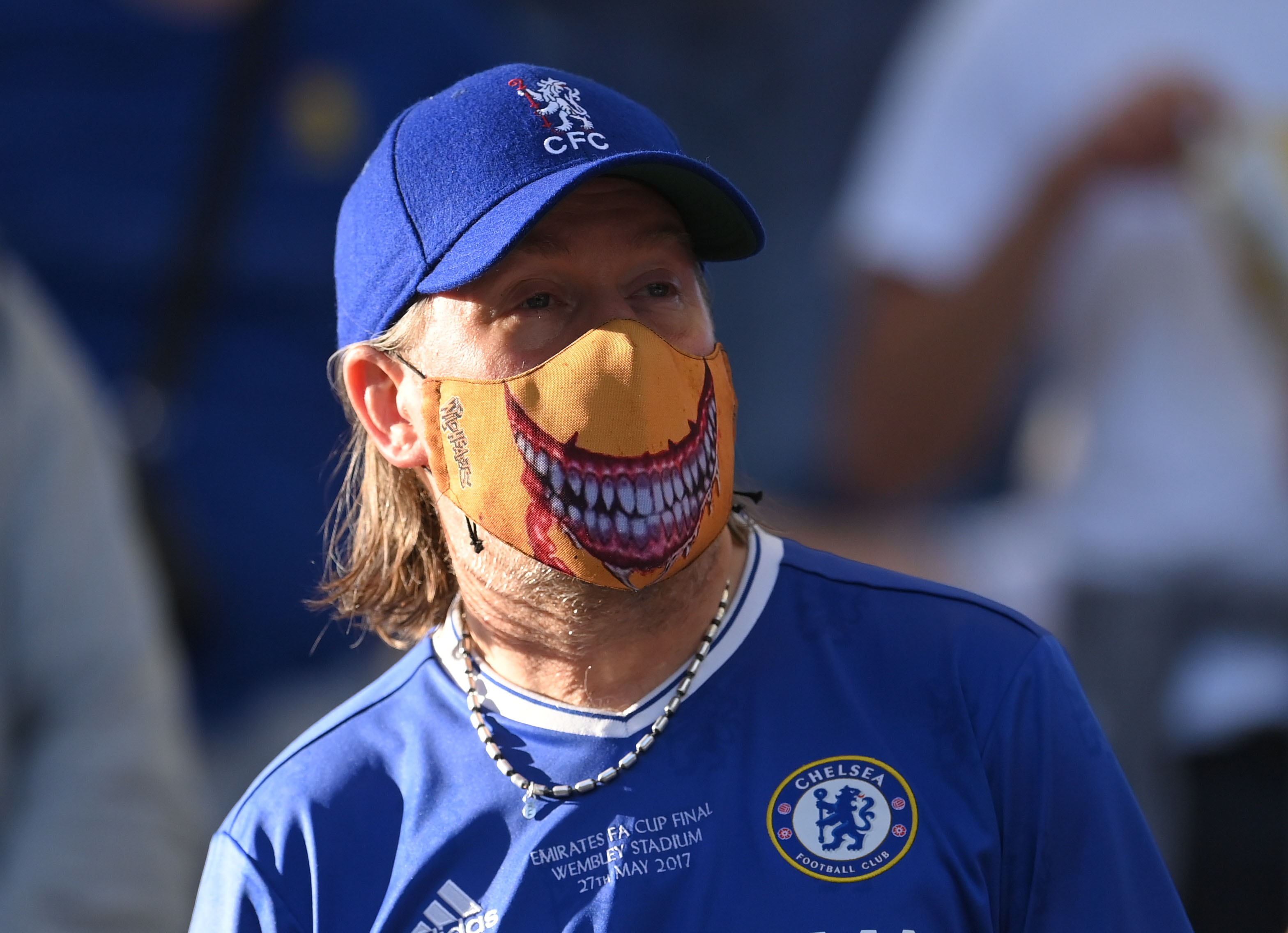 A Chelsea fan wearing a protective face mask inside the stadium before the match