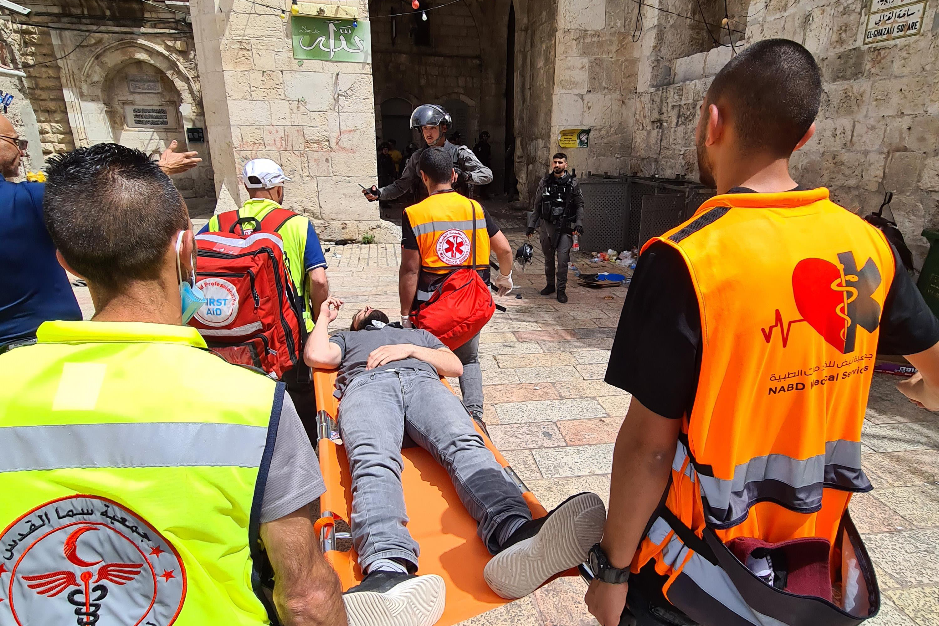 Palestinian medics evacuating a wounded man outside of the Al-Aqsa Mosque compound