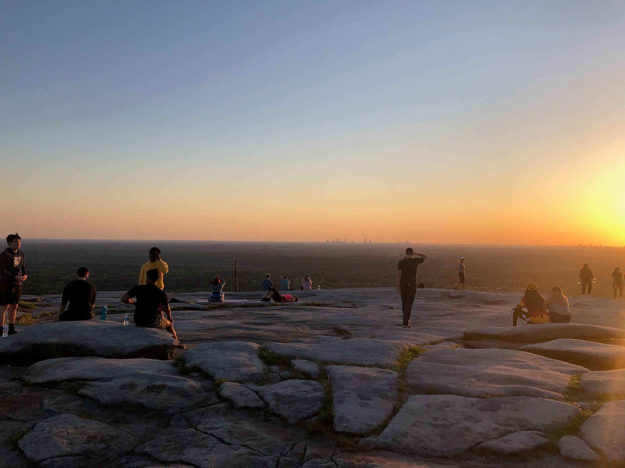 Parkgoers take in the view from atop Stone Mountain. The Atlanta, Georgia, skyline can be seen in the distance