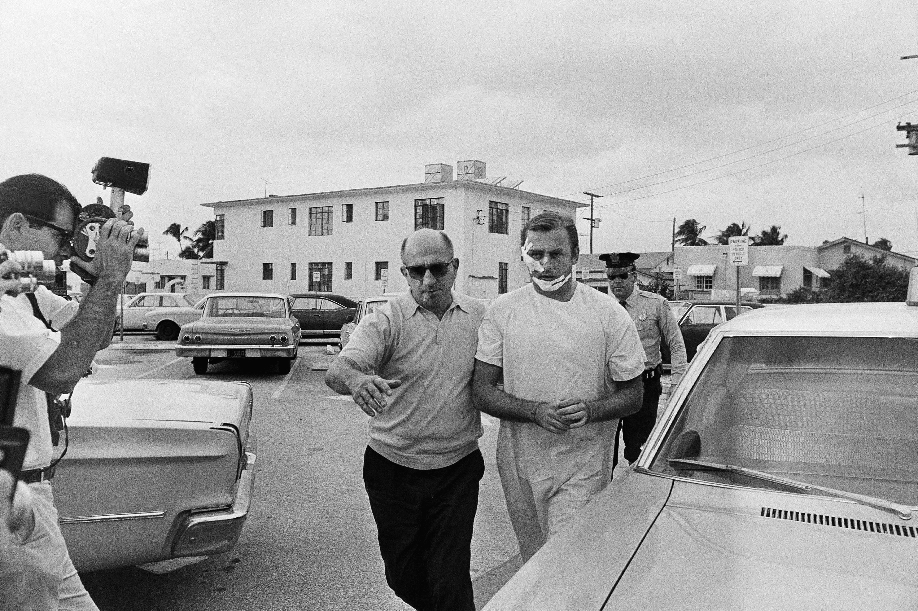 Jack Murphy is escorted to the Miami Beach Police Station by detectives after he was arrested for armed robbery in 1968
