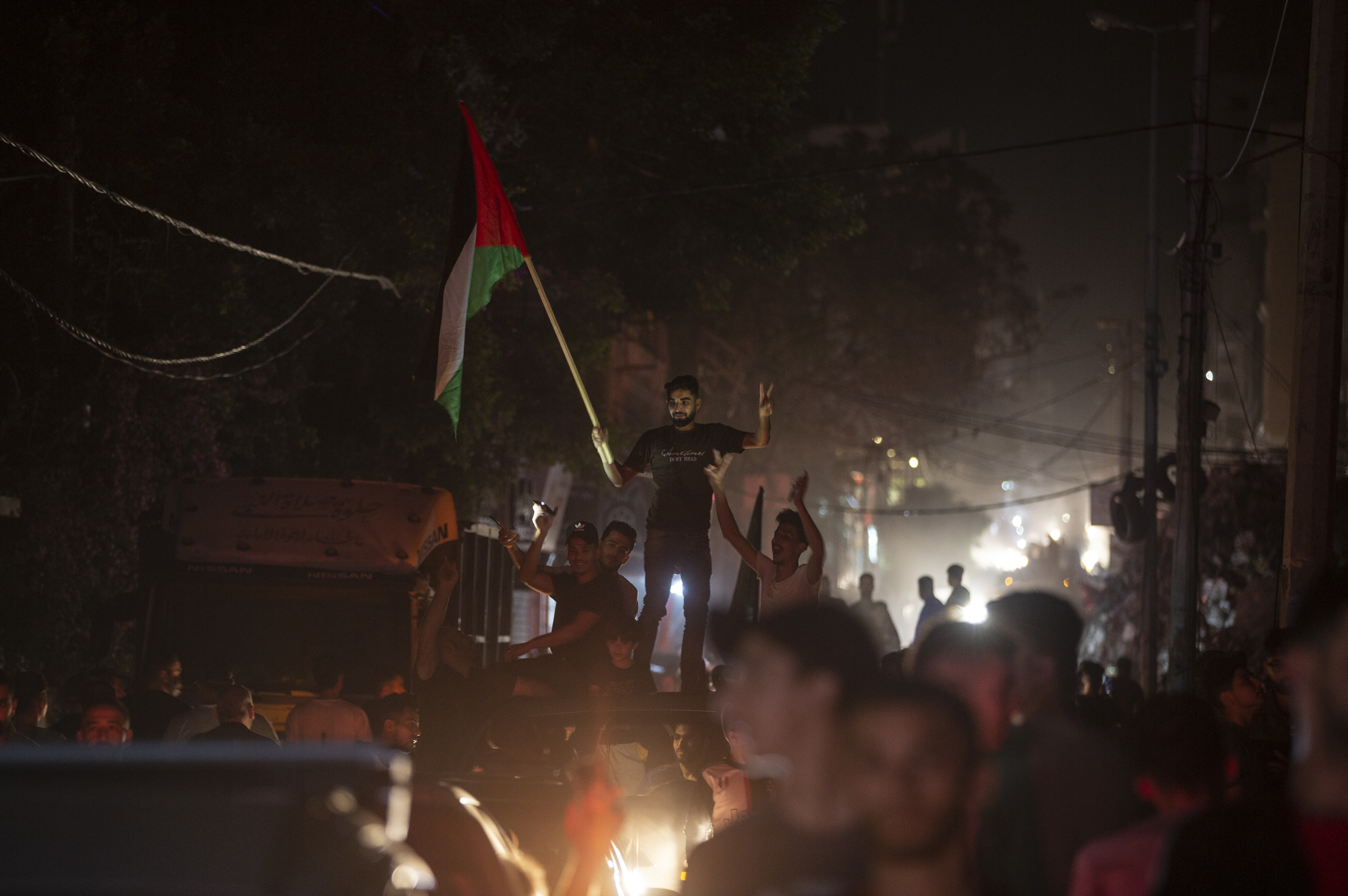Palestinians chant slogans celebrating the ceasefire