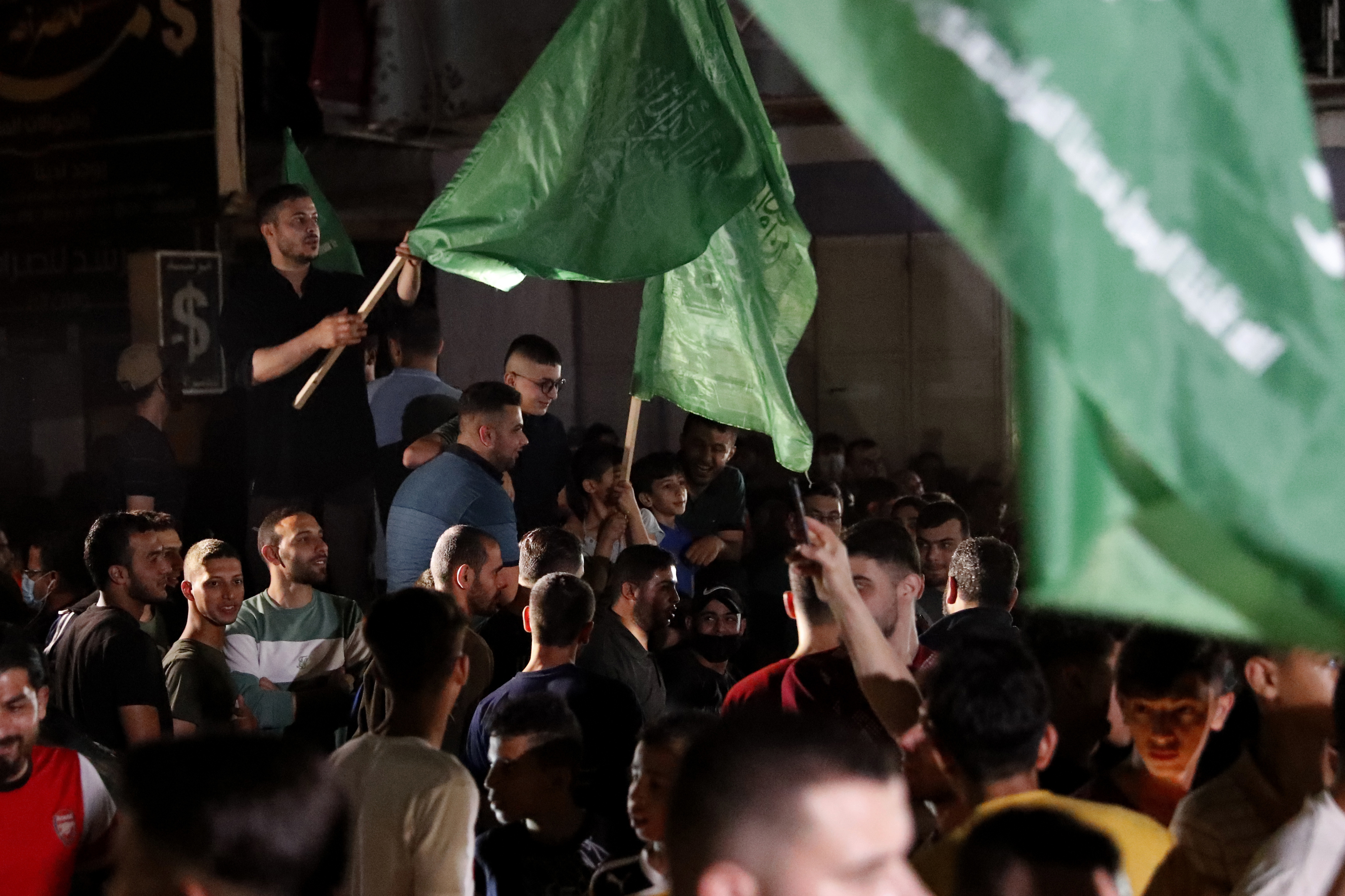 People wave Hamas flags on the streets of Gaza City