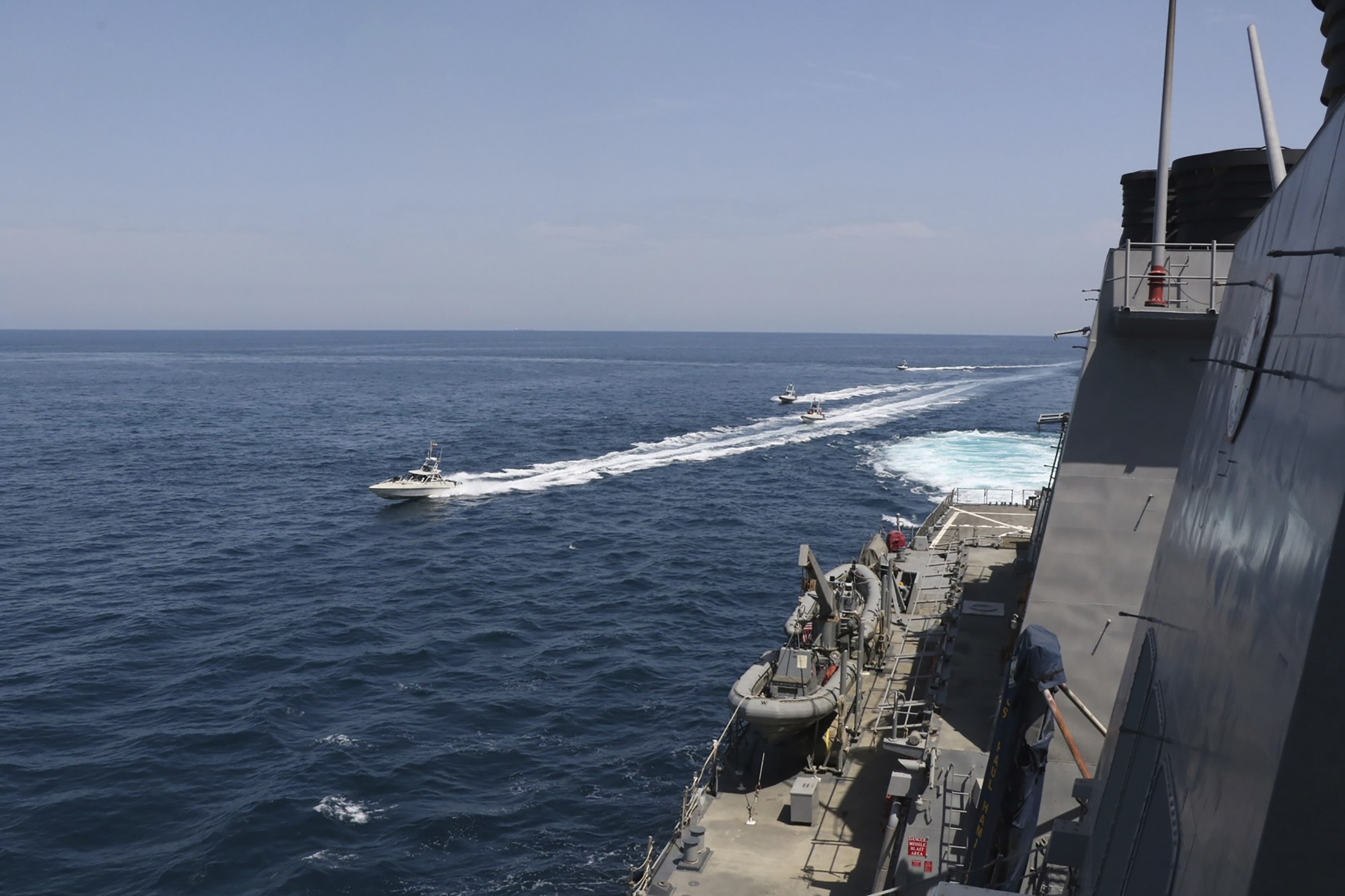 Iranian Revolutionary Guard vessels sail close to US military ships in the Persian Gulf near Kuwait in this April 15, 2020 photo