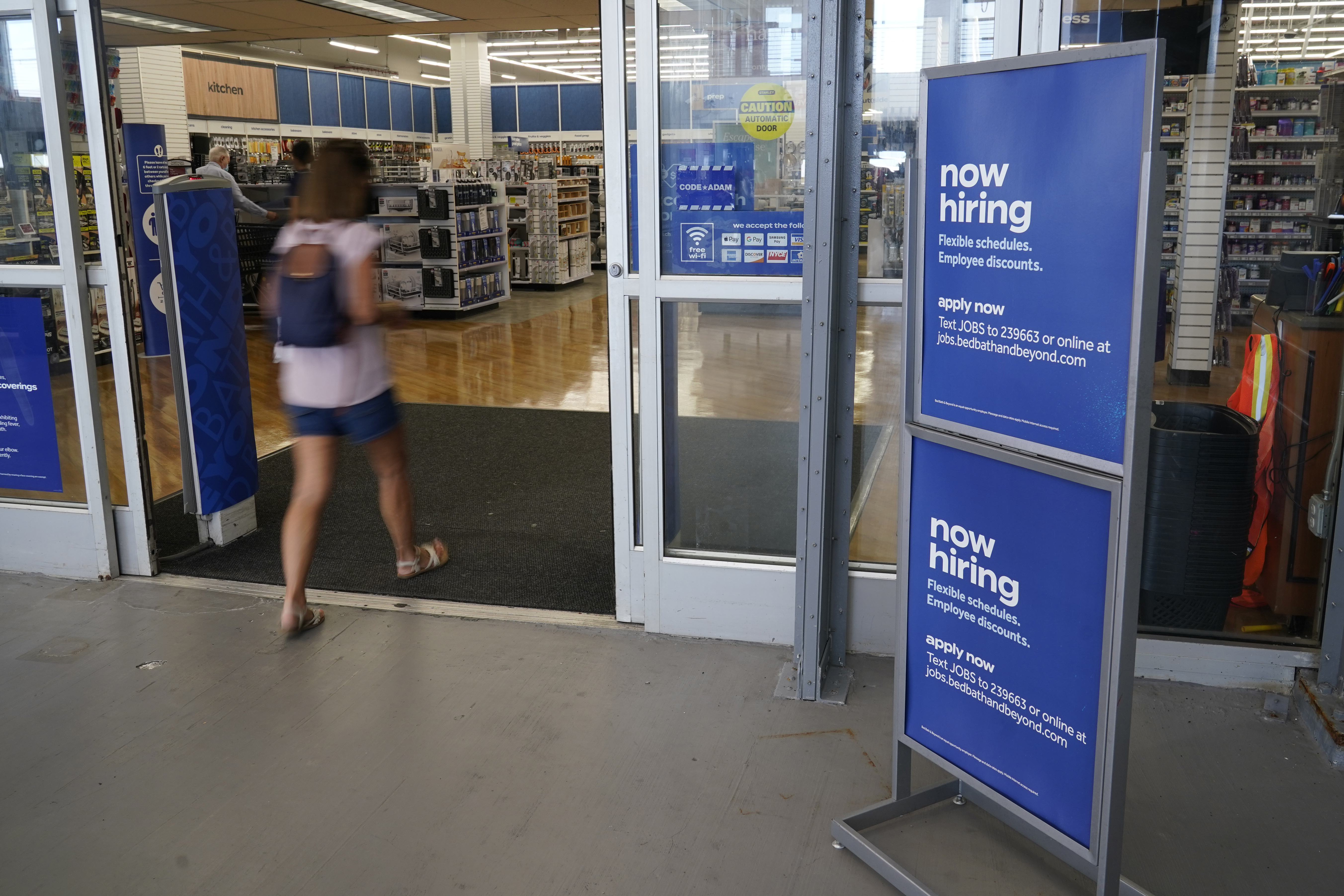 A sign looking to hire employees is displayed at the entrance to a Bed, Bath and Beyond store in Miami, US