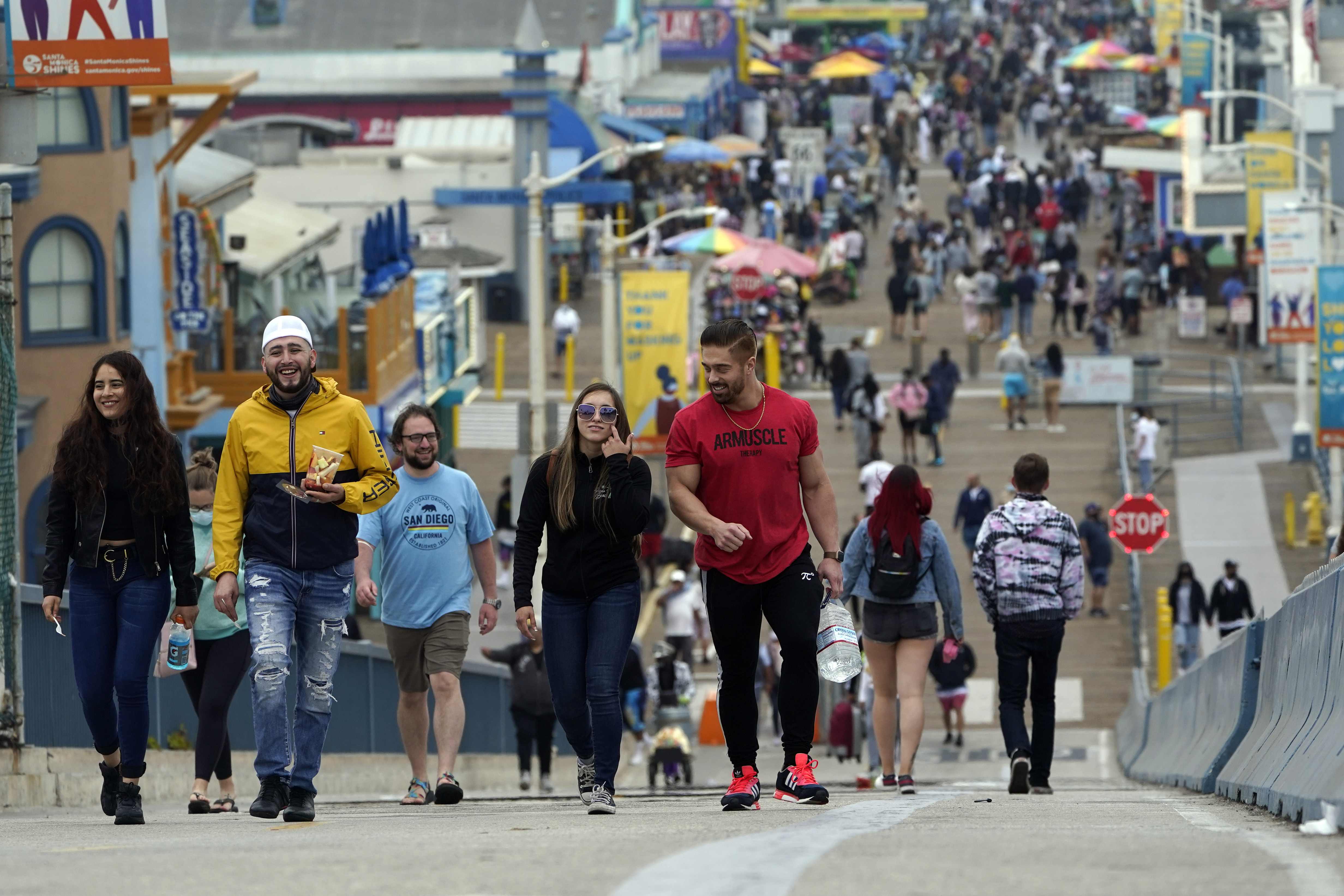 Crowds walking without masks on the pier in Santa Monica, California