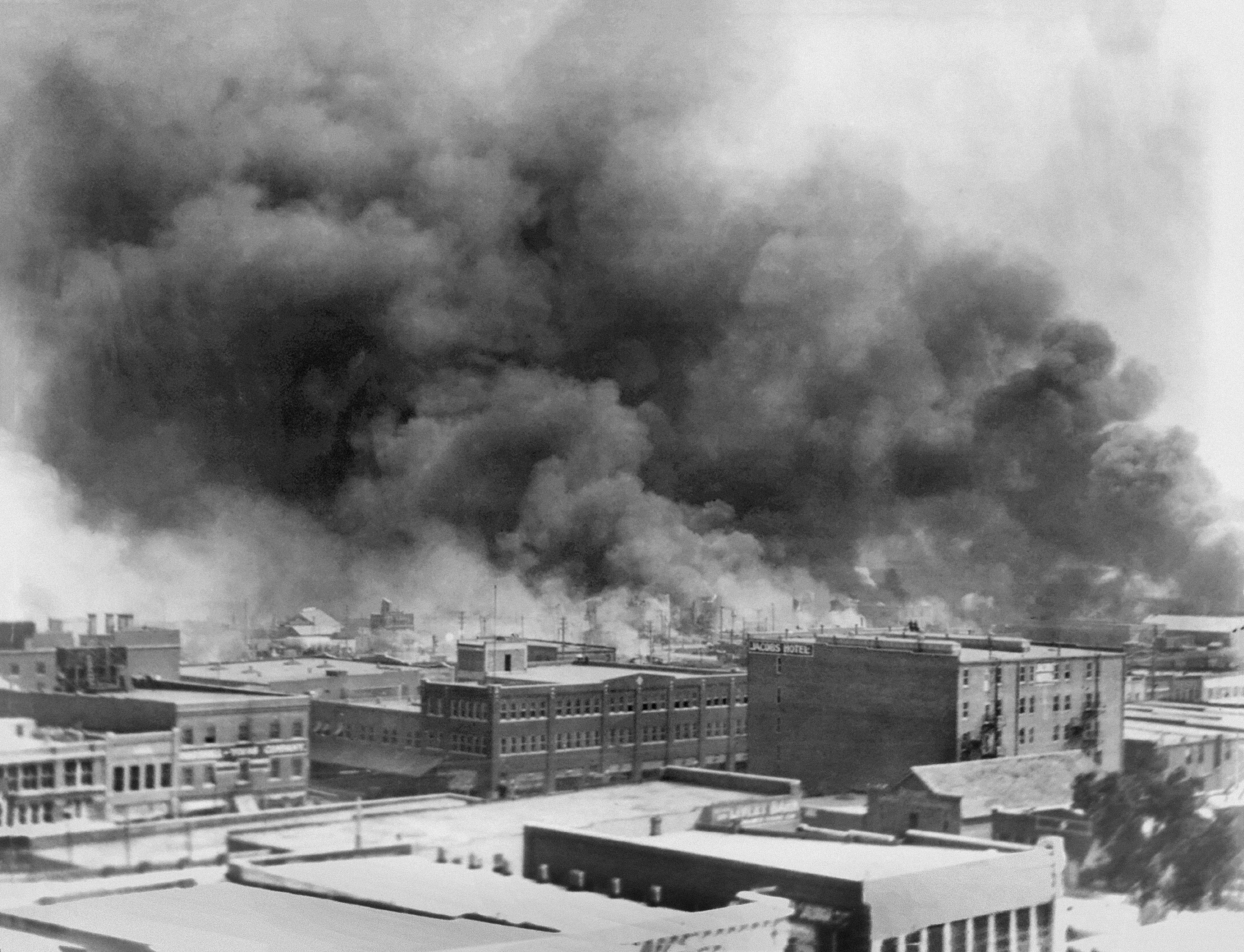 Billowing smoke is seen during the race massacre
