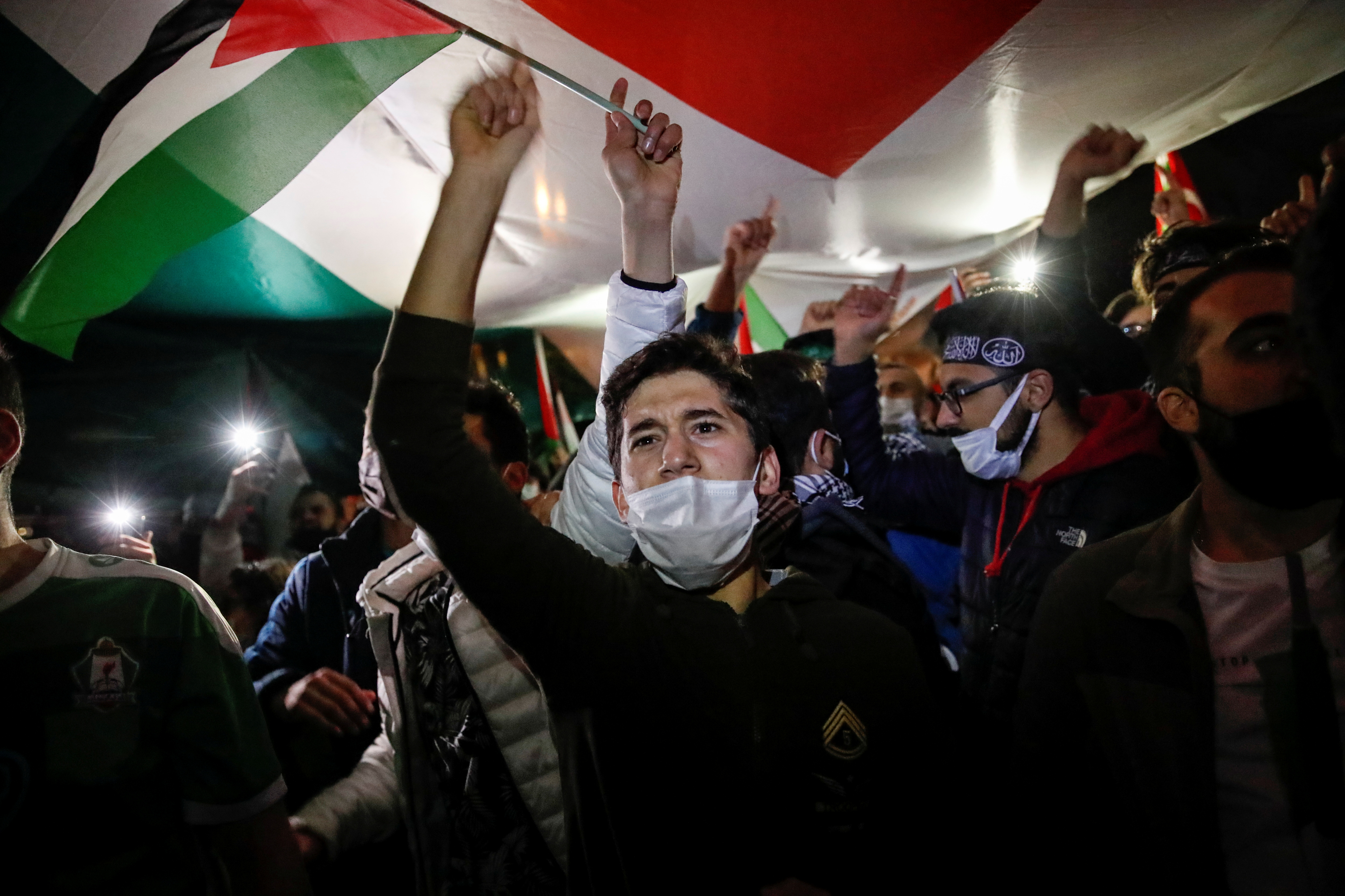 Demonstrators wave Palestinian flags during a protest near the Israeli consulate in Istanbul