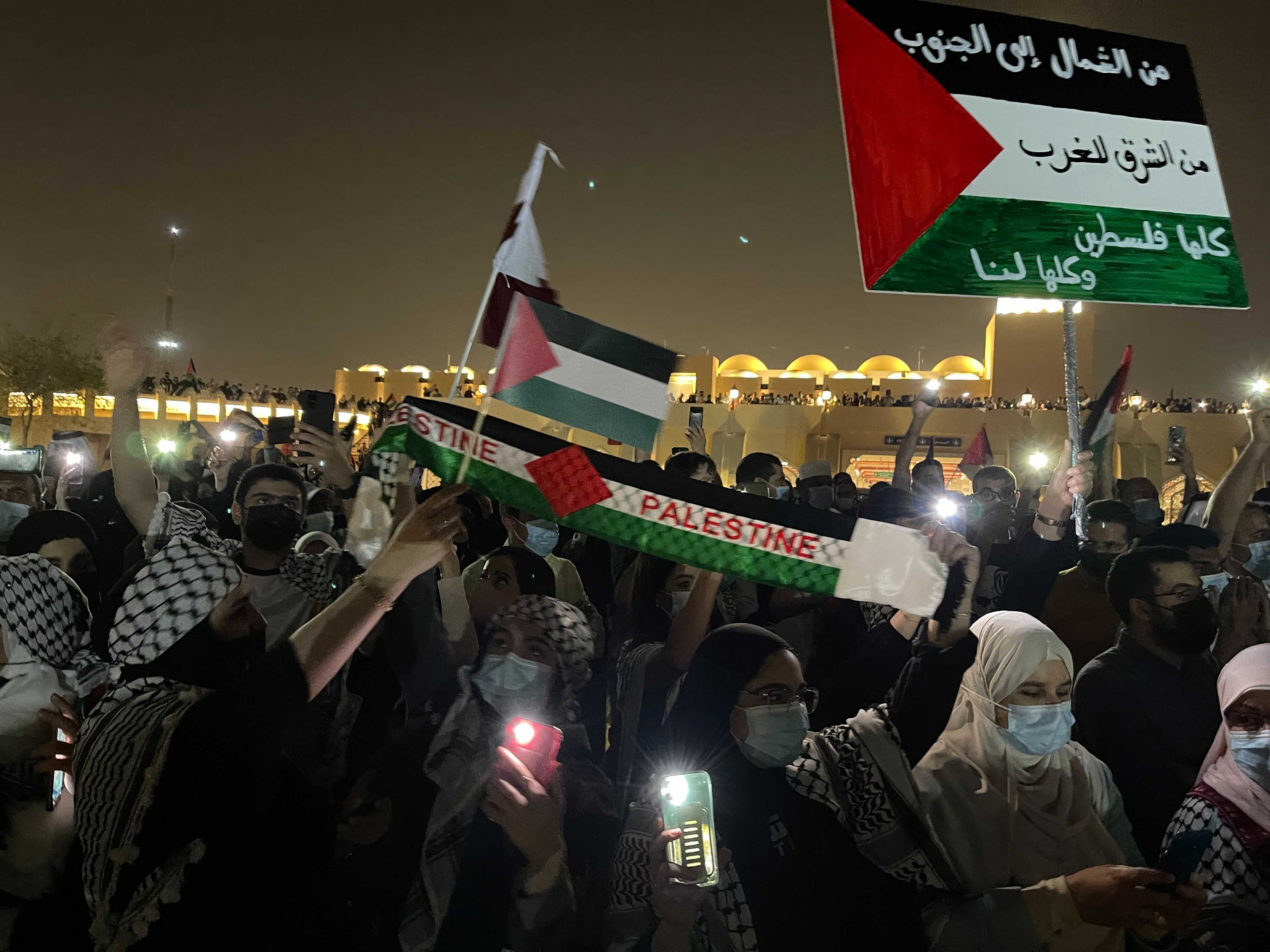 Protesters wave Palestinian flags in Doha, Qatar