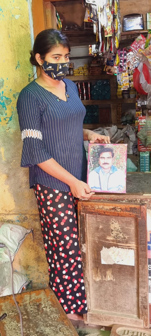 Richa Gupta holds a picture of her late father