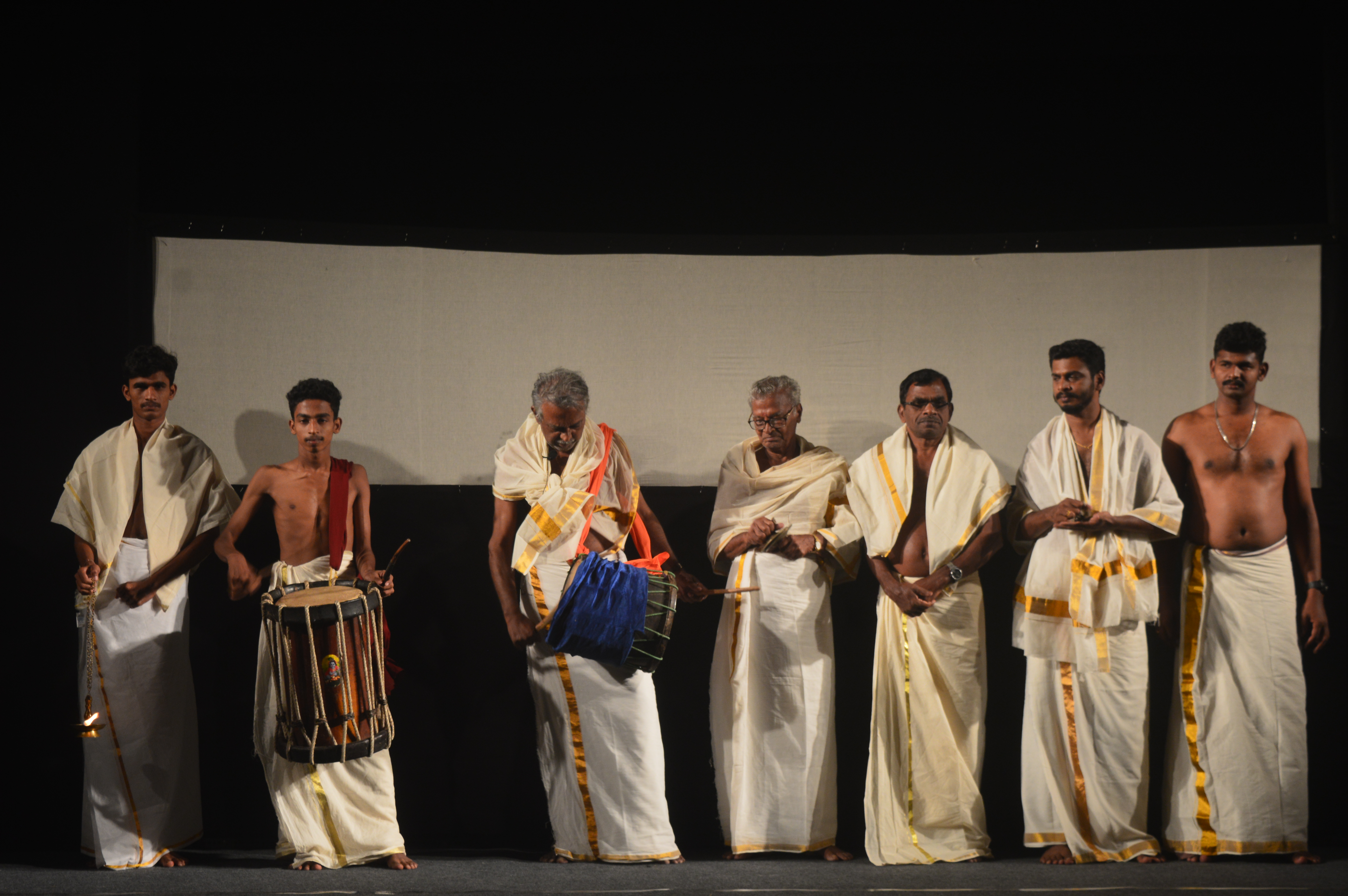 A performance team in front of a stage