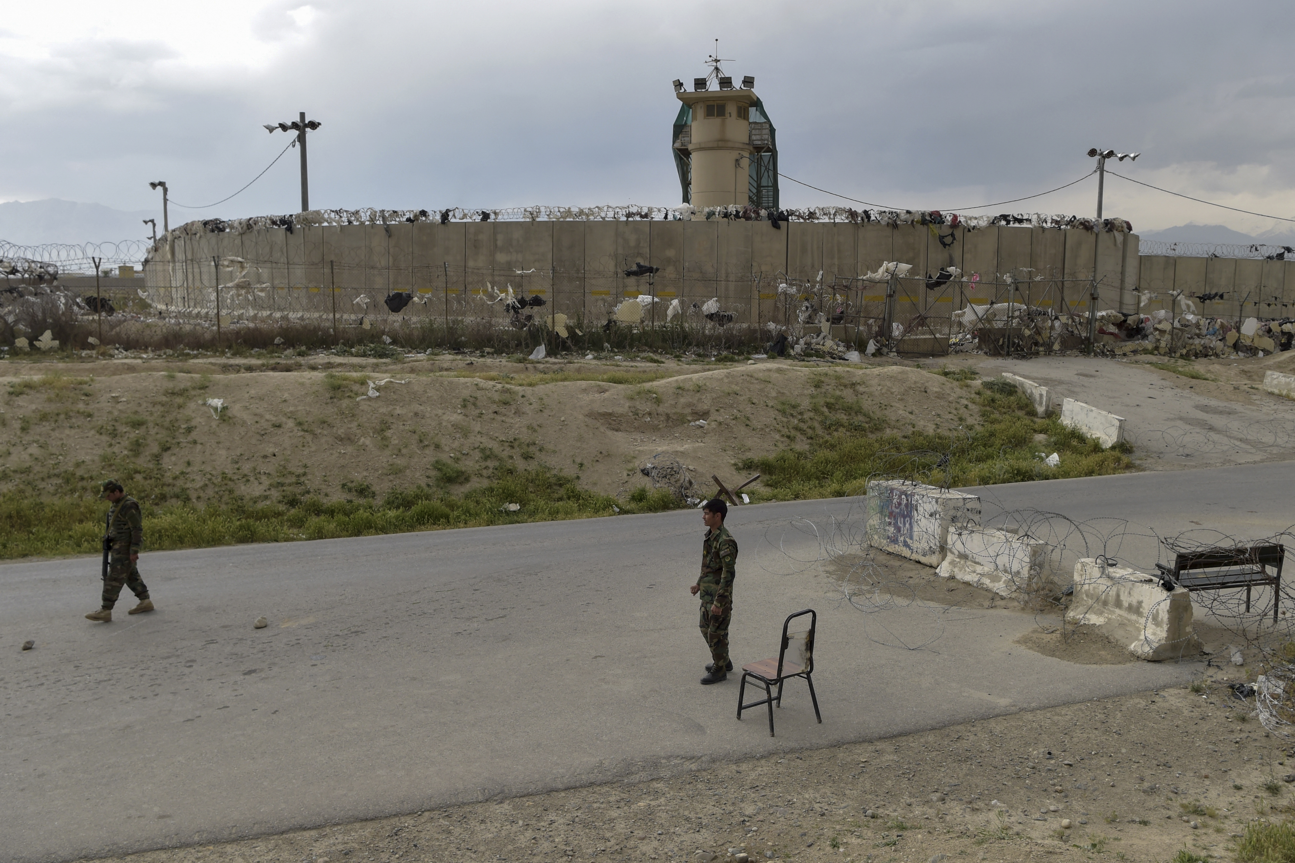 Afghan soldiers stand guard at a checkpoint outside Bagram airbase