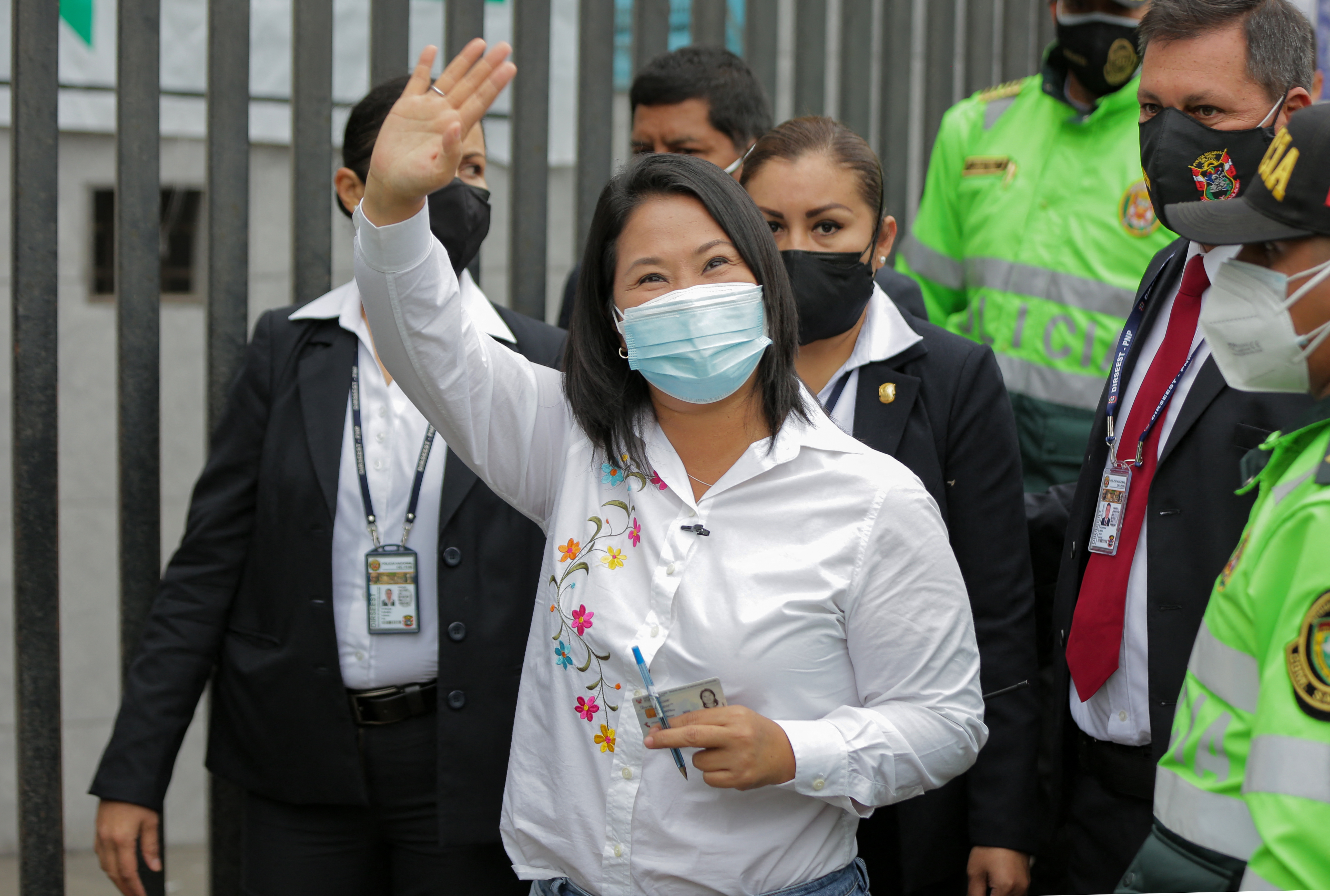 Peruvian presidential candidate, right-wing Keiko Fujimori, waves to her supporters as she leaves the polling station after casting her vote, during the presidential runoff election in Lima, on June 6, 2021