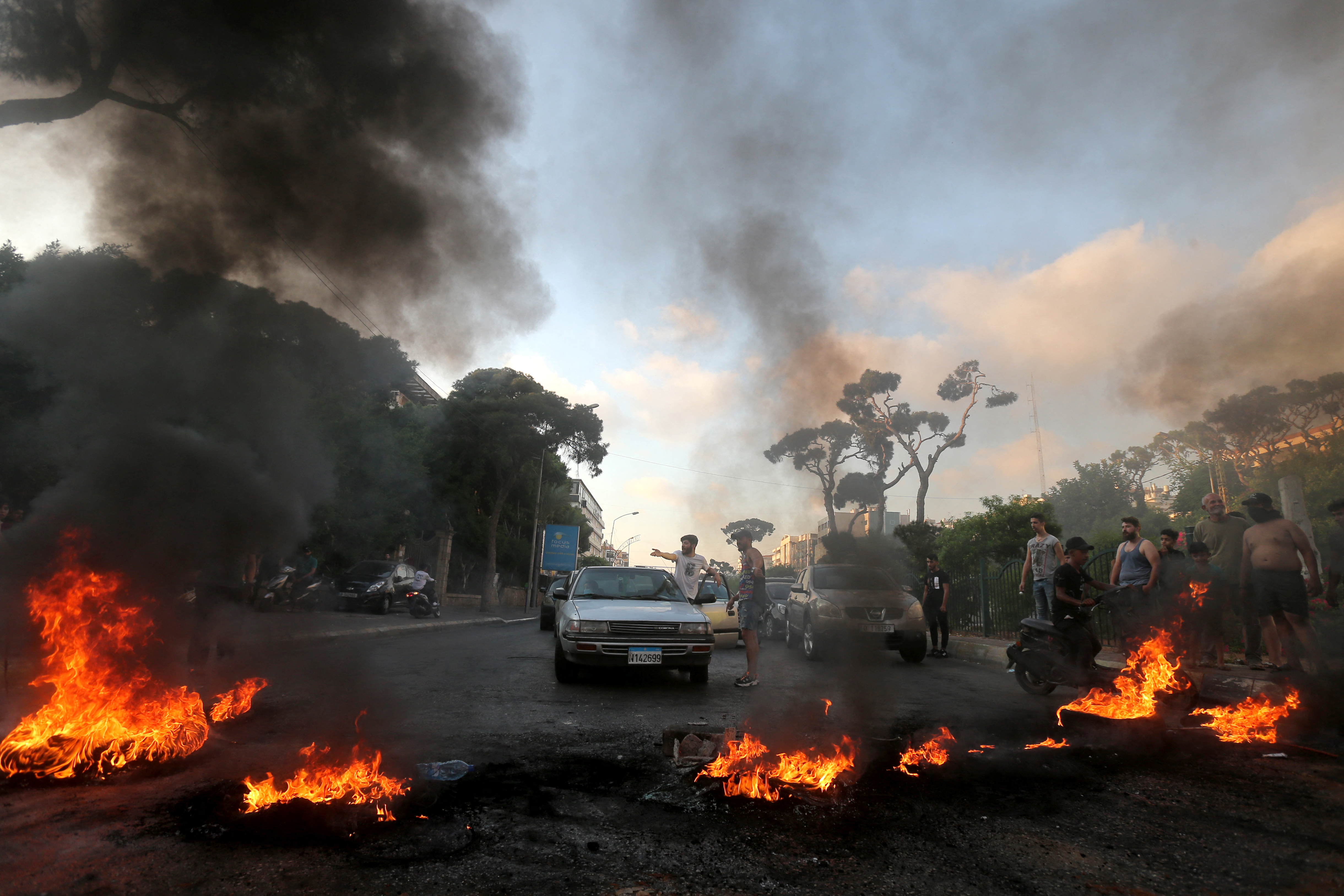 Lebanese youths burn tyres to block a main highway in the area of Jal el-Dib, east of the capital Beirut, as they protest against the country’s dire living conditions [AFP]