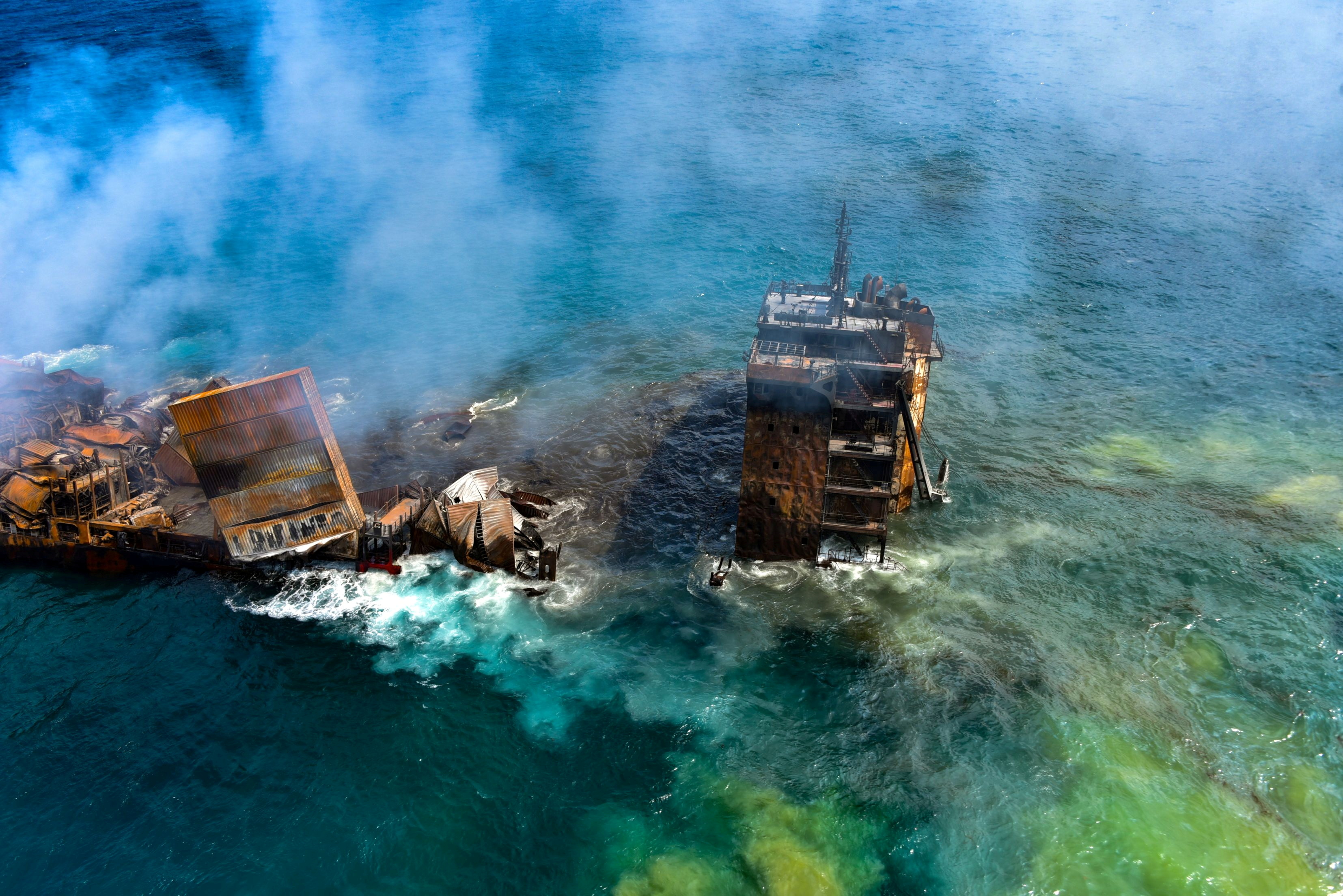 Smoke rises from a fire onboard the MV X-Press Pearl vessel as it sinks while being towed into deep sea off the Colombo Harbour in Sri Lanka