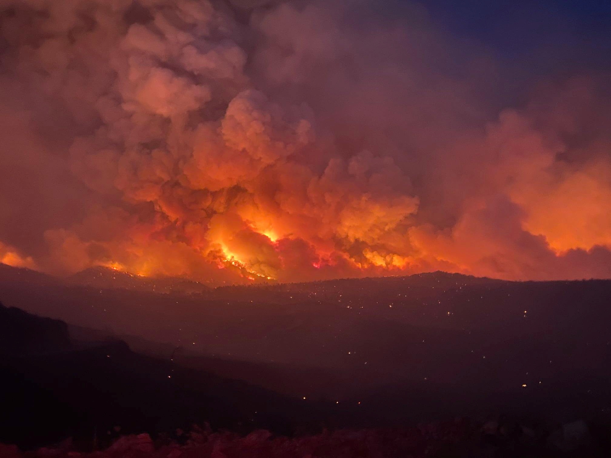 Smoke plumes rise from a blaze as a wildfire rages on in Arizona, June 7, 2021, in this image obtained from social media.