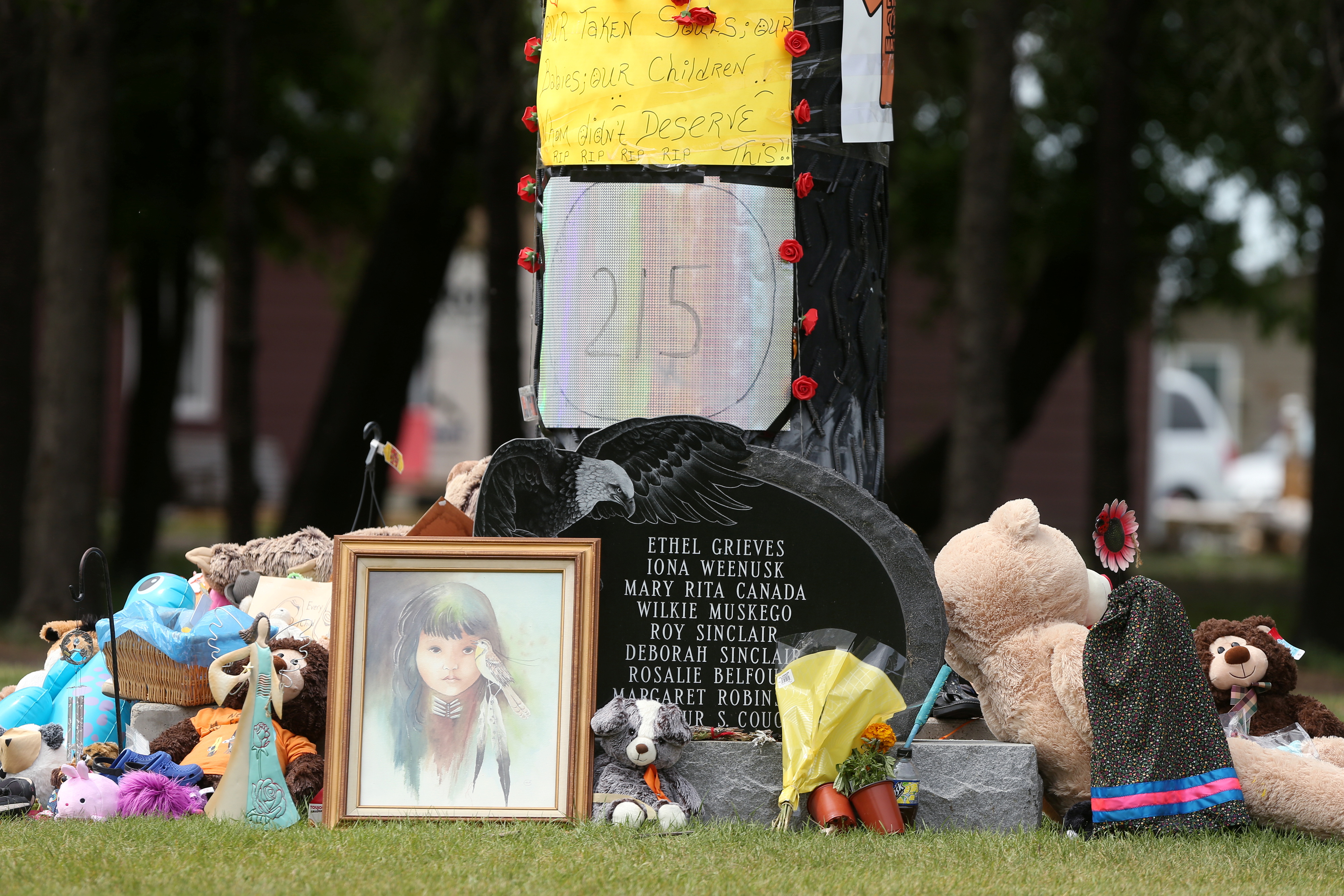 Children’s shoes, toys, candy, tobacco and flowers are left on a memorial at the Portage La Prairie Indian Residential School, after the discovery of unmarked graves at other institutions