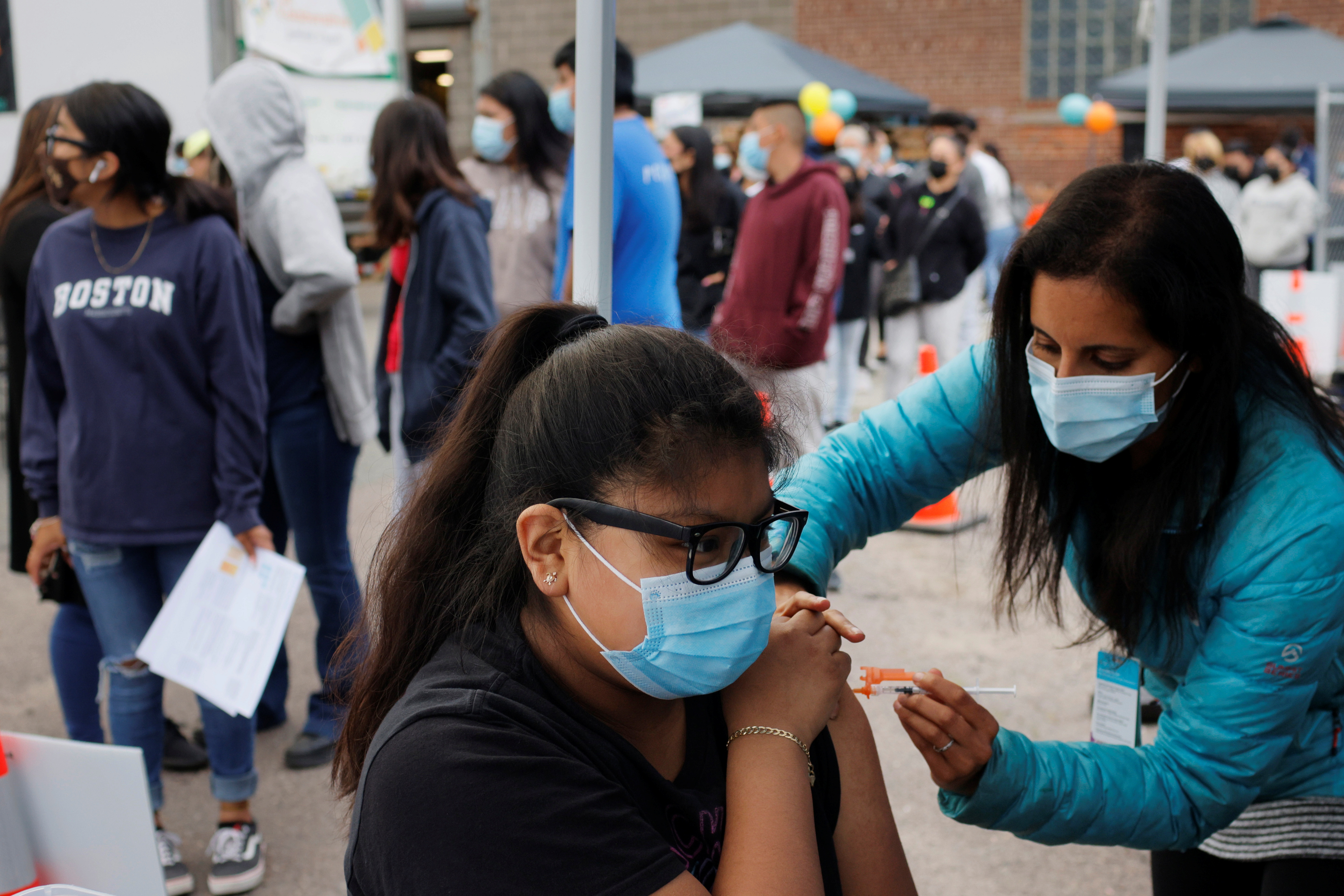A teenager receiving a vaccination dose in Chelsea, Massachusetts