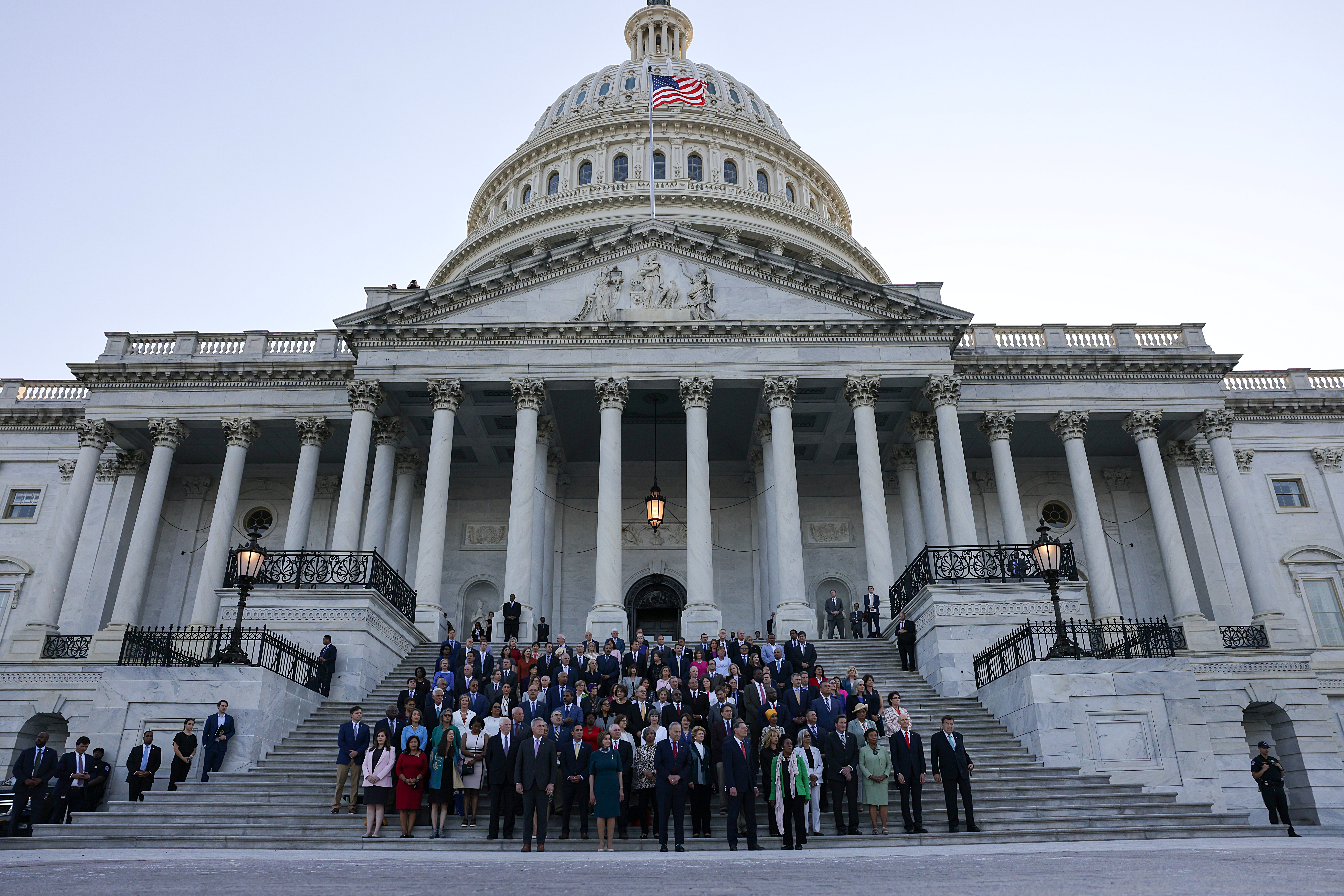 Members of Congress observing a moment of silence for the 600,000 American lives lost to COVID-19, outside the US Capitol in Washington, DC