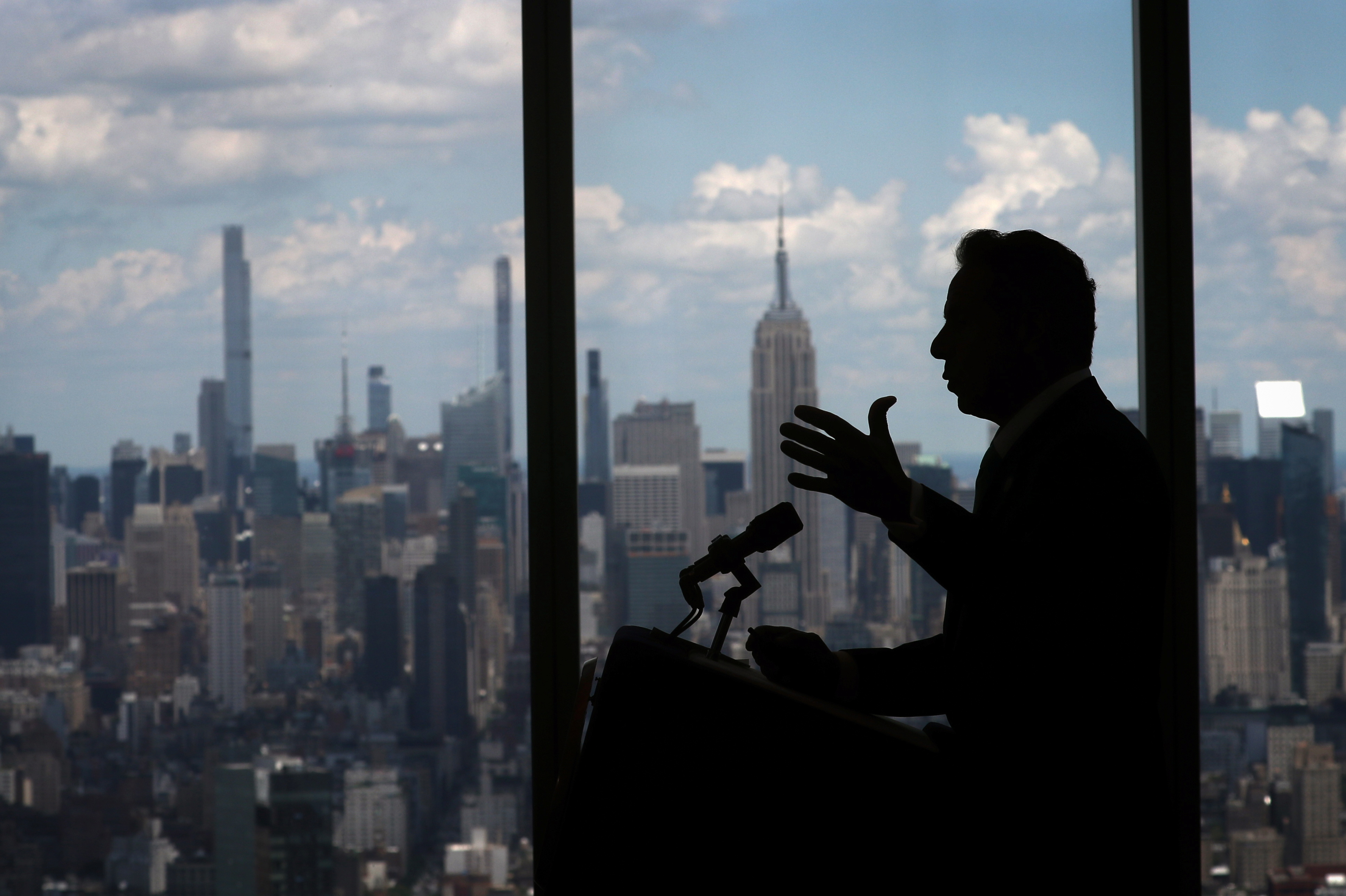 New York Governor Andrew Cuomo speaks with the skyline of Manhattan behind him from the One World Trade Center Tower while announcing his state is easing pandemic restrictions, New York City, June 15, 2021