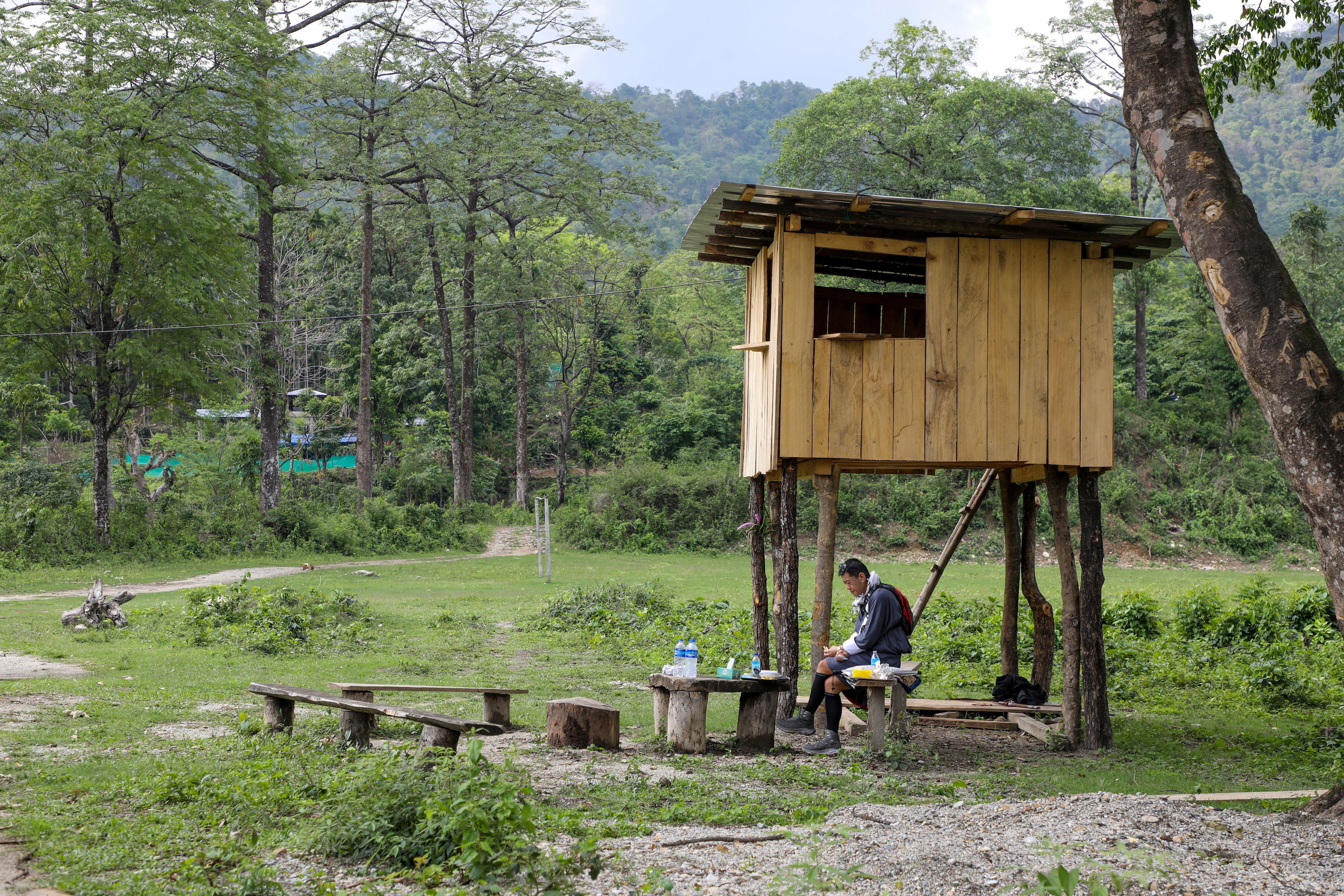 Bhutan’s King Jigme Khesar Namgyel Wangchuck takes his lunch at a security outpost during his visit to a remote village