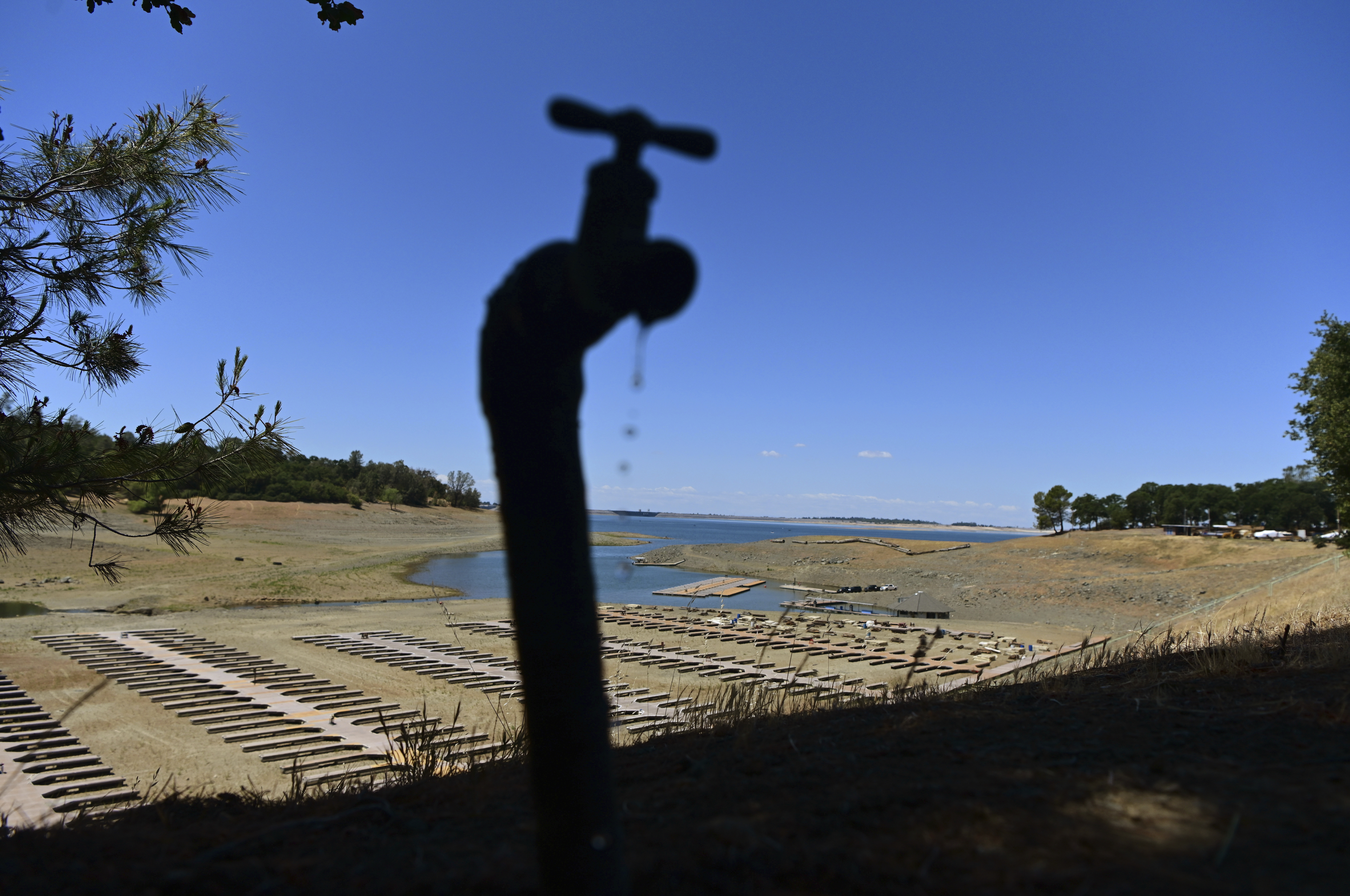 Water drips from a faucet near boat docks sitting on dry land at the Browns Ravine Cove area of drought-stricken Folsom Lake, currently at 37 percent of its normal capacity, in Folsom, California, May 22, 2021