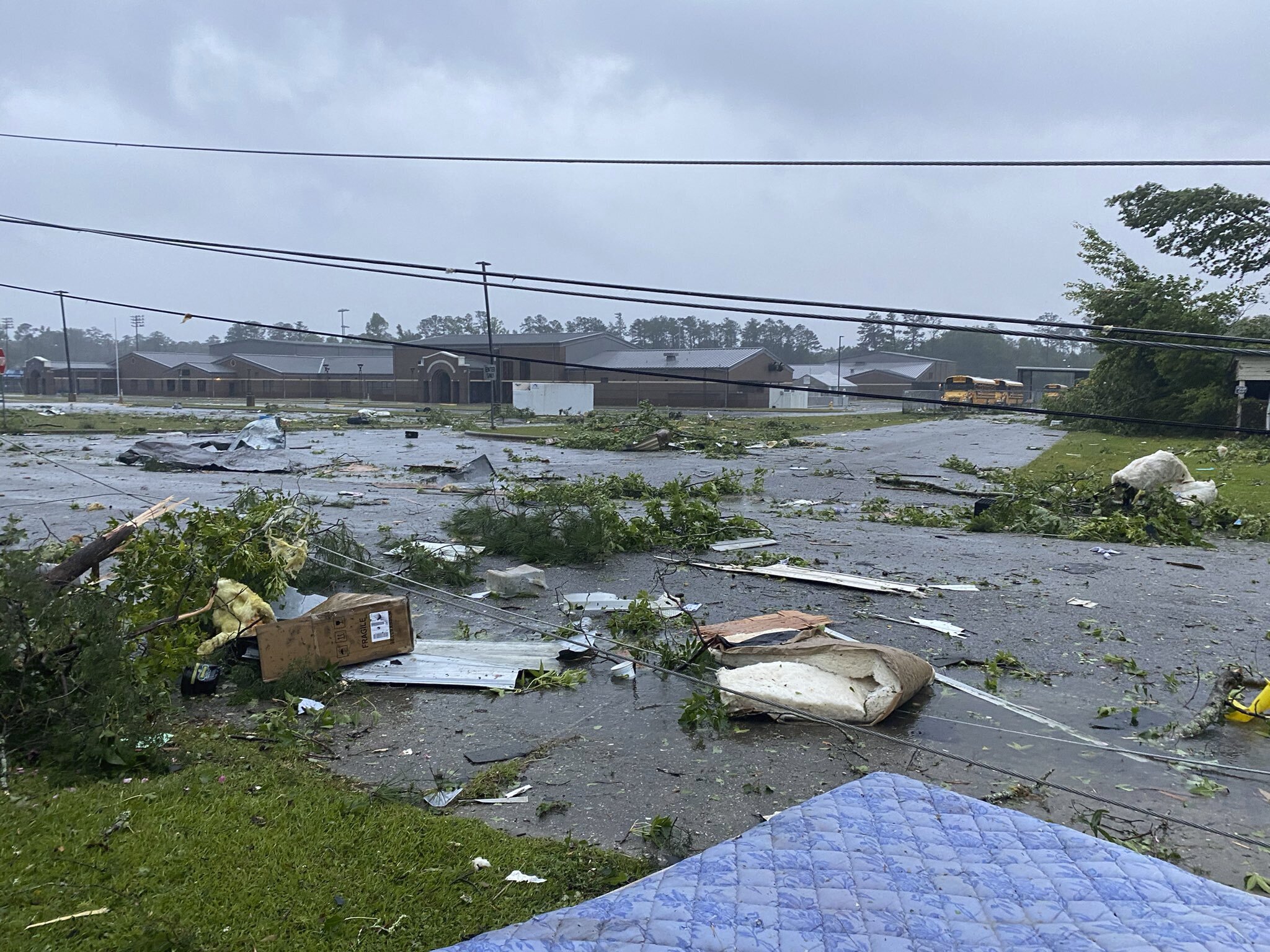 Debris covering the street in East Brewton, Alabama [Alicia Jossey via AP Photo]