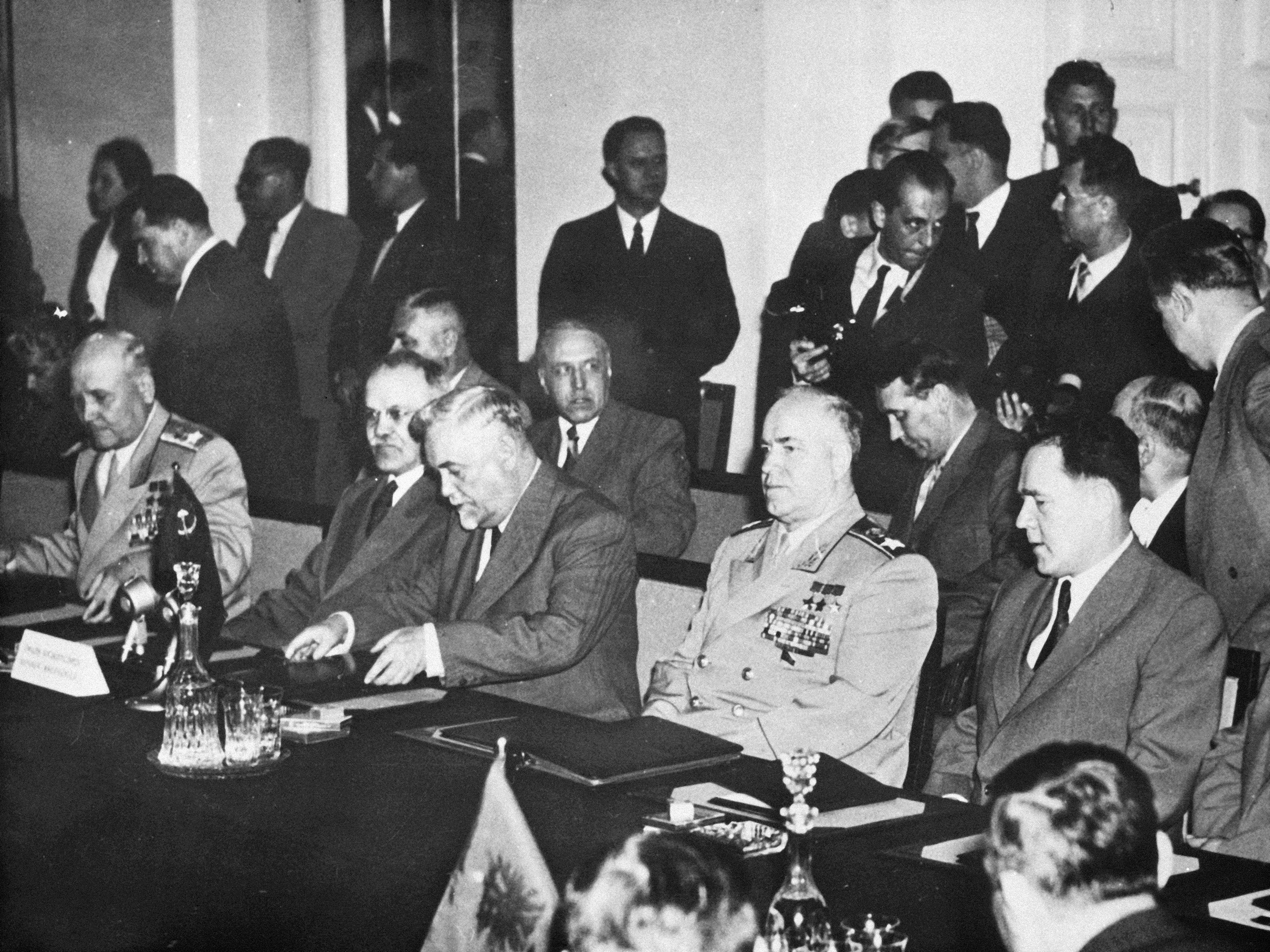 Soviet leaders draft a treaty to establish a unified military command to rival NATO in the parliament building in Warsaw, Poland on May 14, 1955. From left to right: Soviet Marshal Ivan Konev, supreme commander of the alliance; Vyacheslav M. Molotov, Soviet foreign minister; Premier Nikolai Bulganin; and defence minister Georgi Zhukov