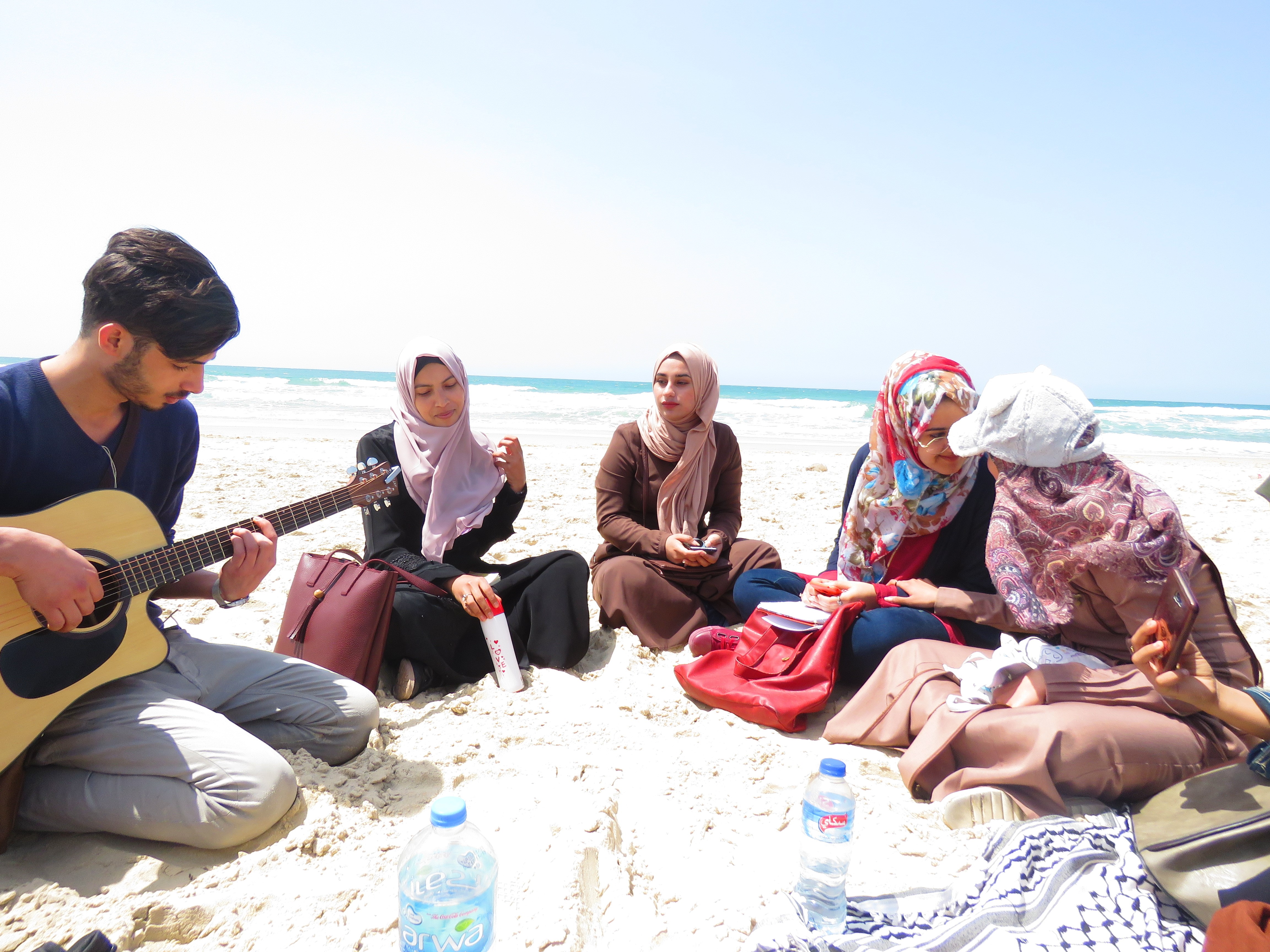 Poets gather on the beach in Gaza, sharing poems and singing songs [Photo courtesy of Mohammed Moussa]