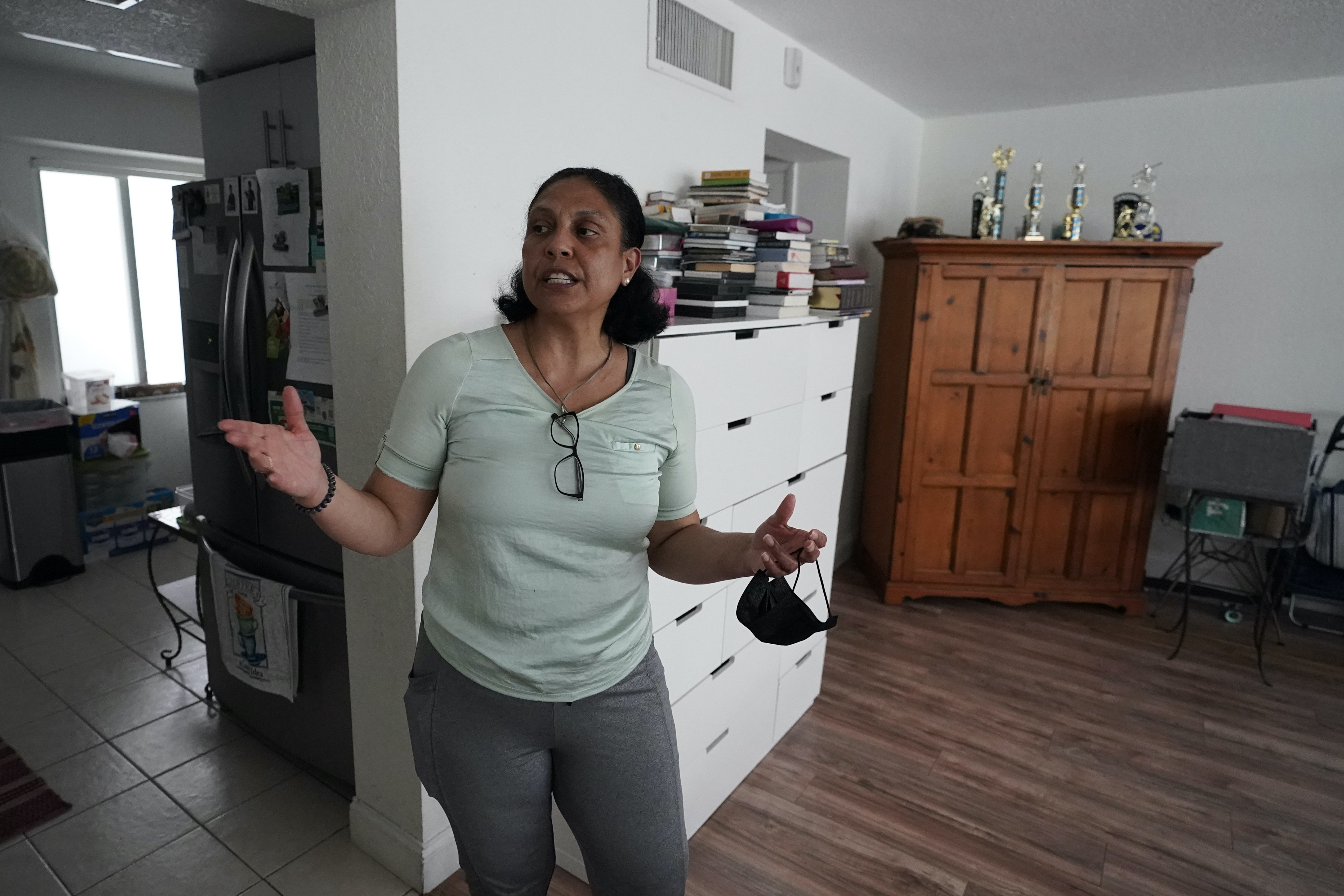 Cristina Livingston recounts the problems she has had in her apartment, including a leaking ceiling and mould at her home in Bay Harbor Islands, Florida, the United States