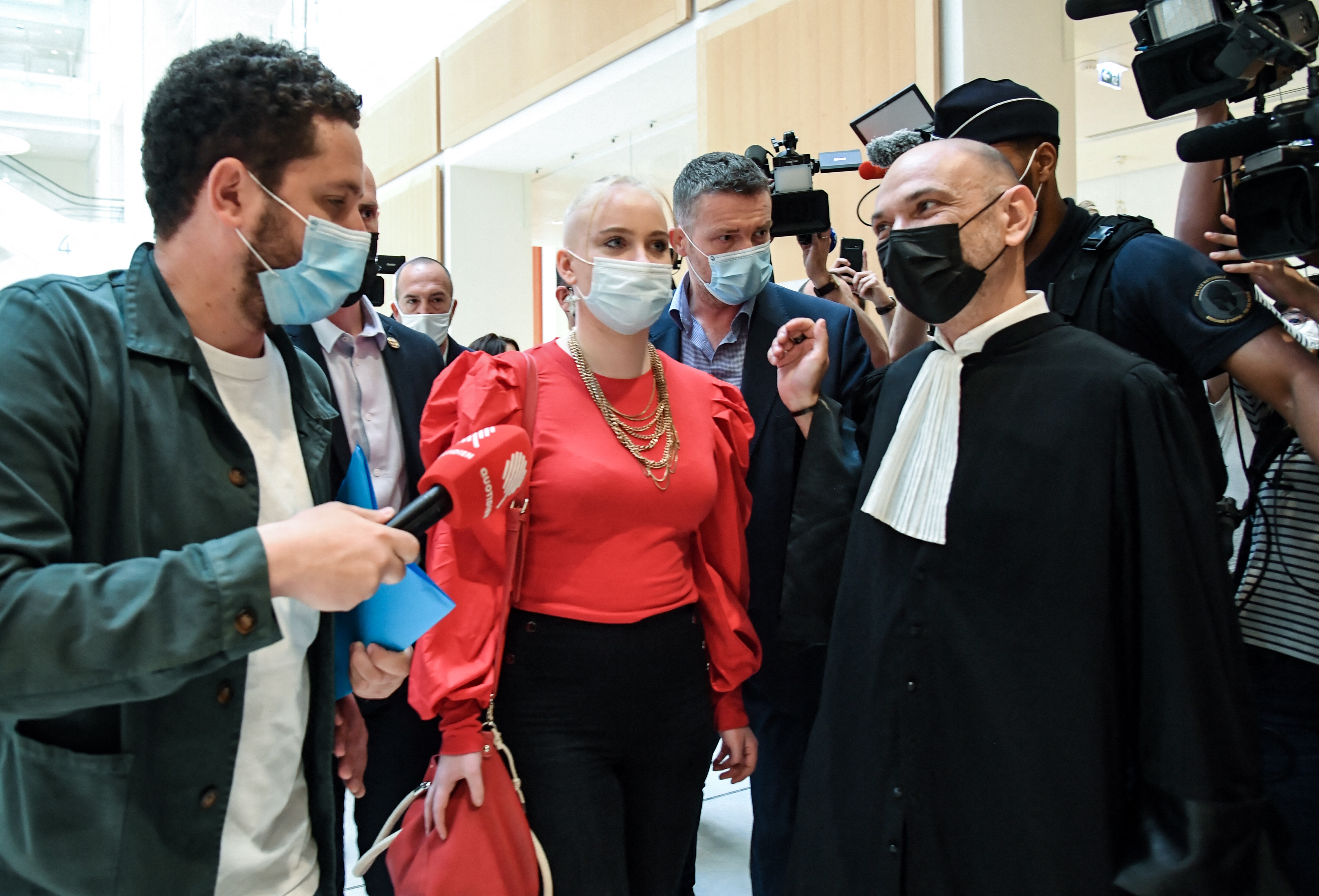 Mila, centre, was forced to change schools and accept police protection due to threats to her life in the wake of her first videos being put online in 2020