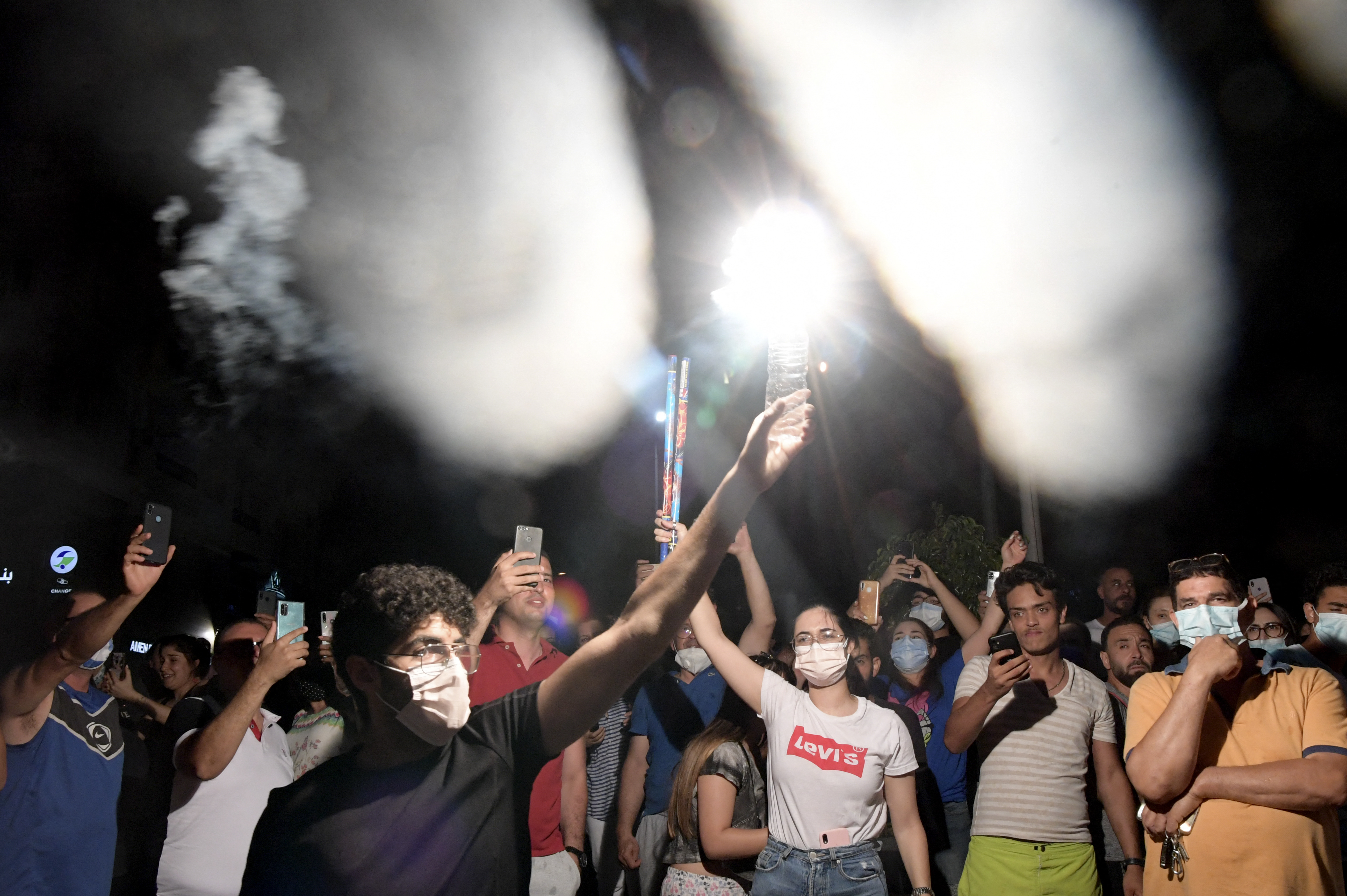 People celebrated in the street after Tunisian President Kais Saied announced the dissolution of parliament and Prime Minister Hichem Mechichi’s government