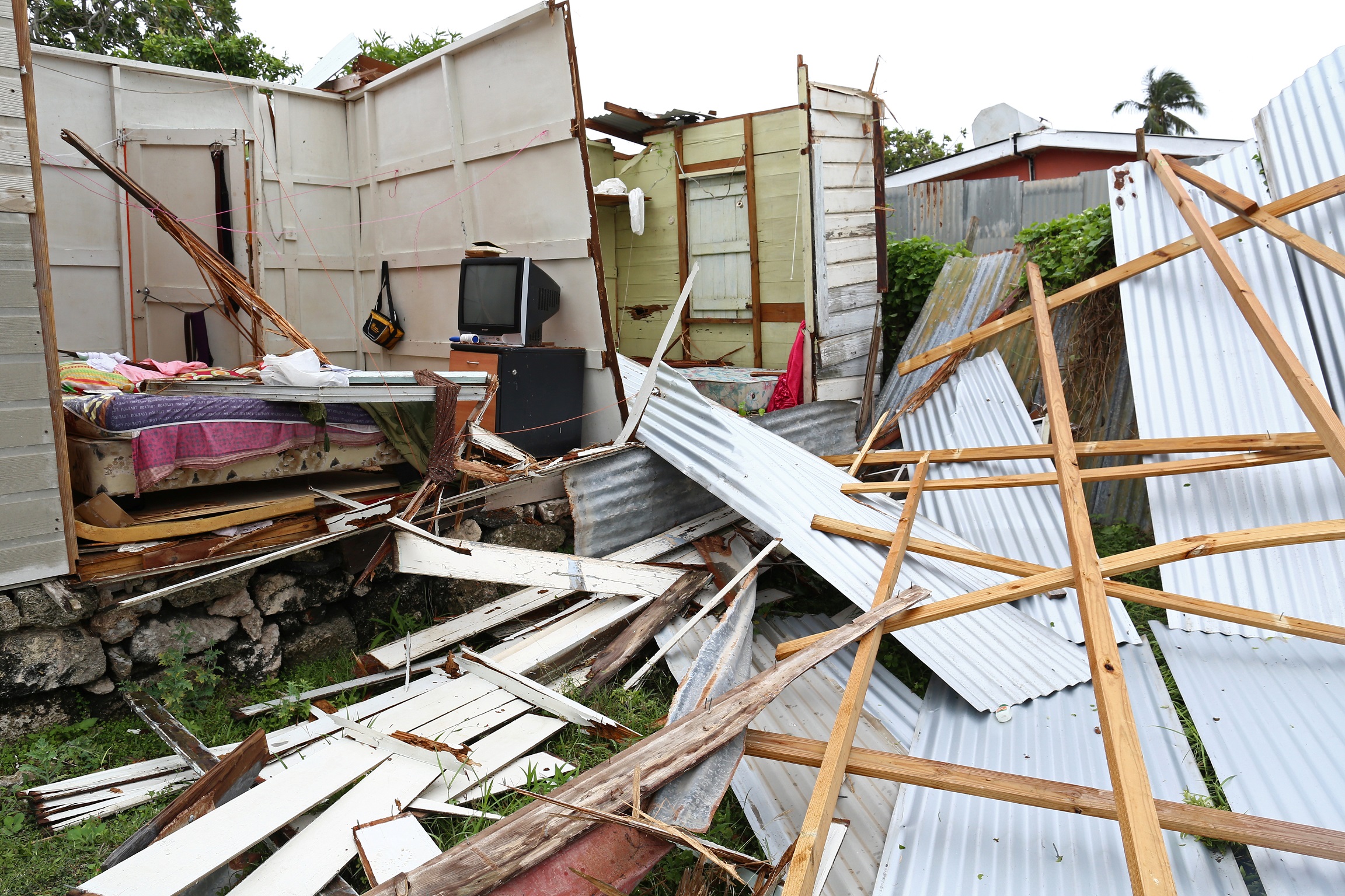 Debris lies in front of a house which lost its roof and walls after strong winds of Hurricane Elsa passed Saint Michael, Barbados on Friday