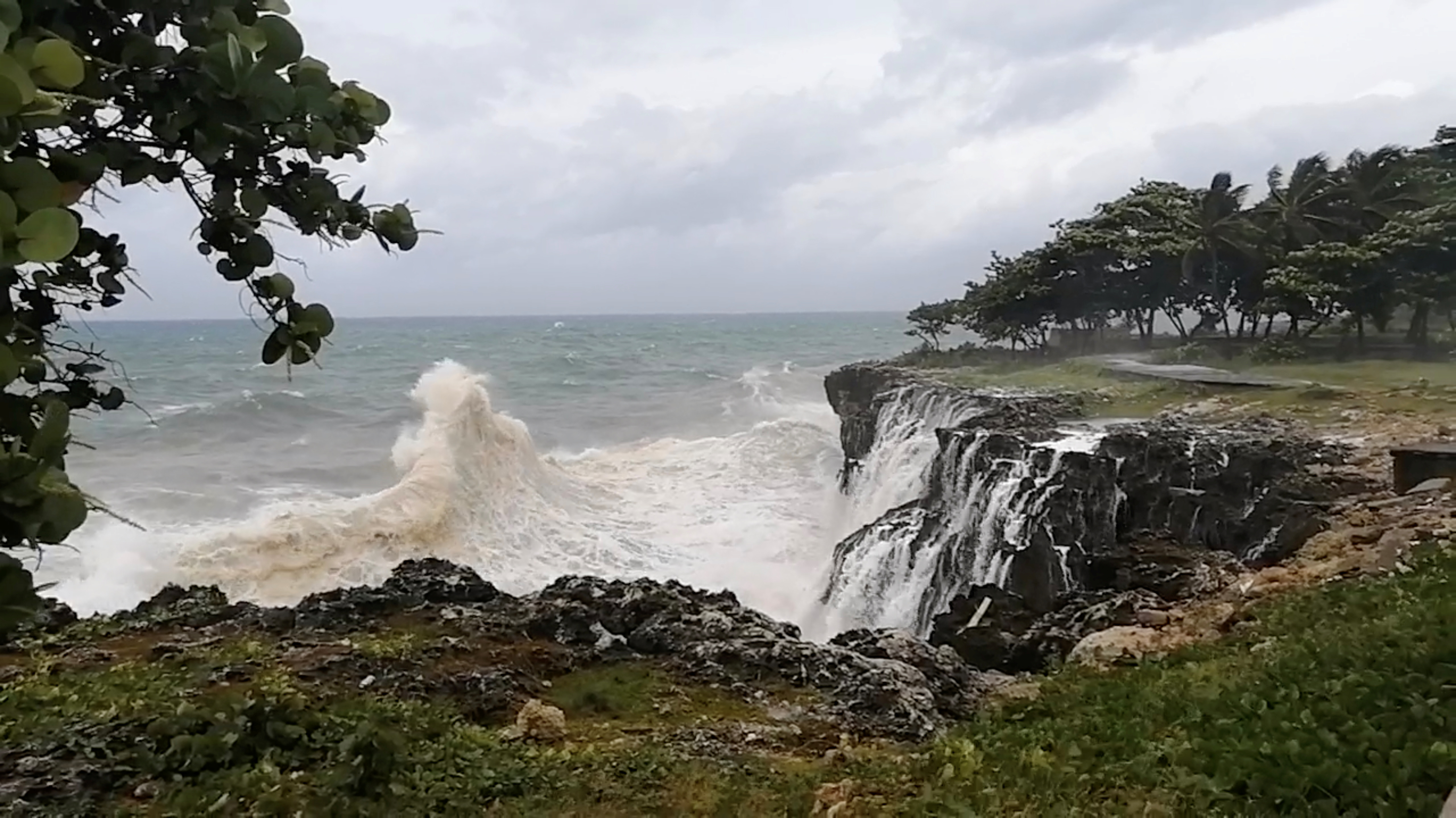 Waters churn along the rocky coastline as Tropical Storm Elsa arrives in Santo Domingo, Dominican Republic on July 3, in this still image taken from social media video [Eloy Contreras via Reuters]