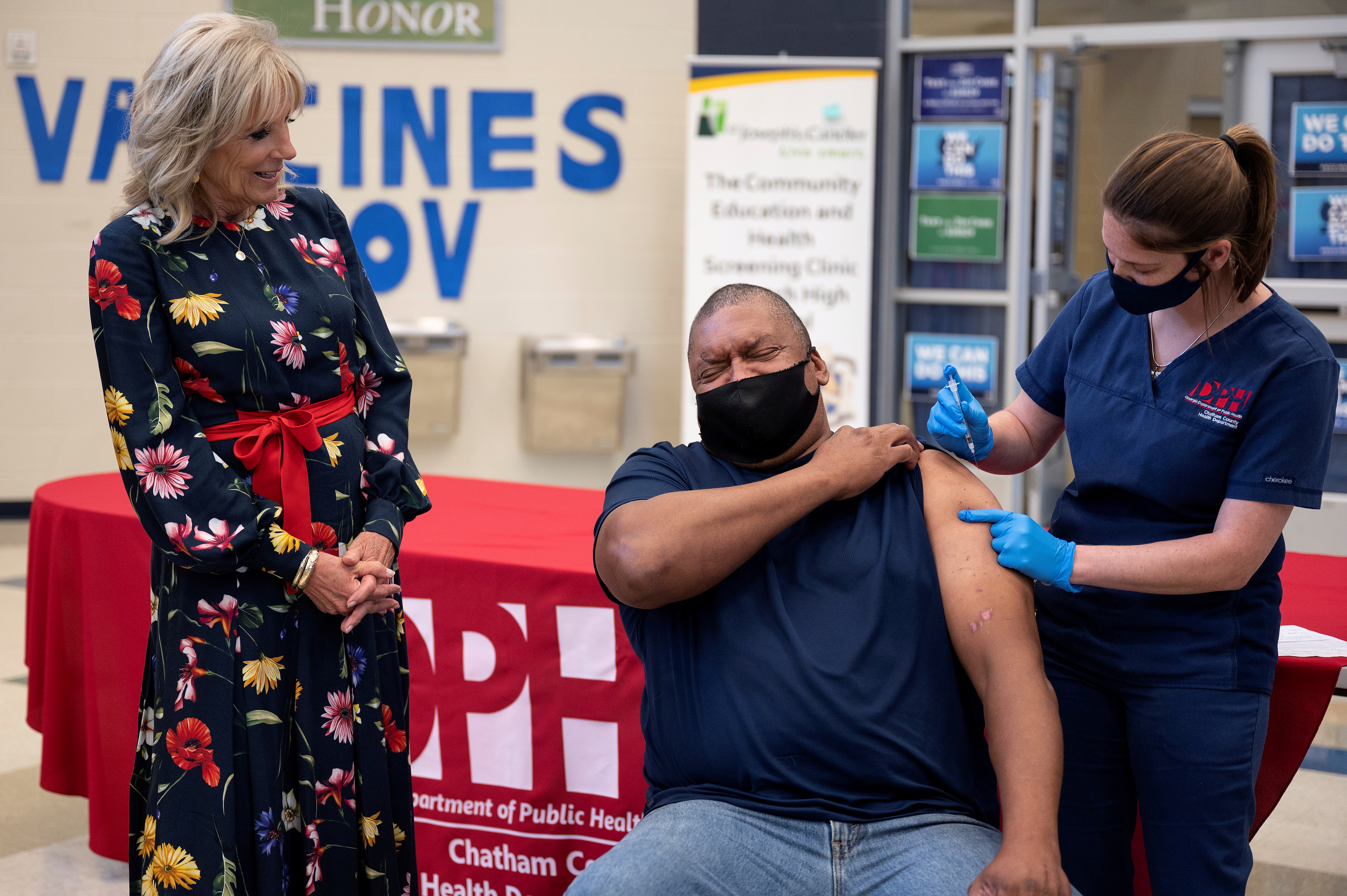 First lady Jill Biden looks on as Alfred Lee Smith is vaccinated with the Johnson & Johnson COVID-19 vaccination at a vaccination facility at Alfred E. Beach High School in Savannah, Georgia, US