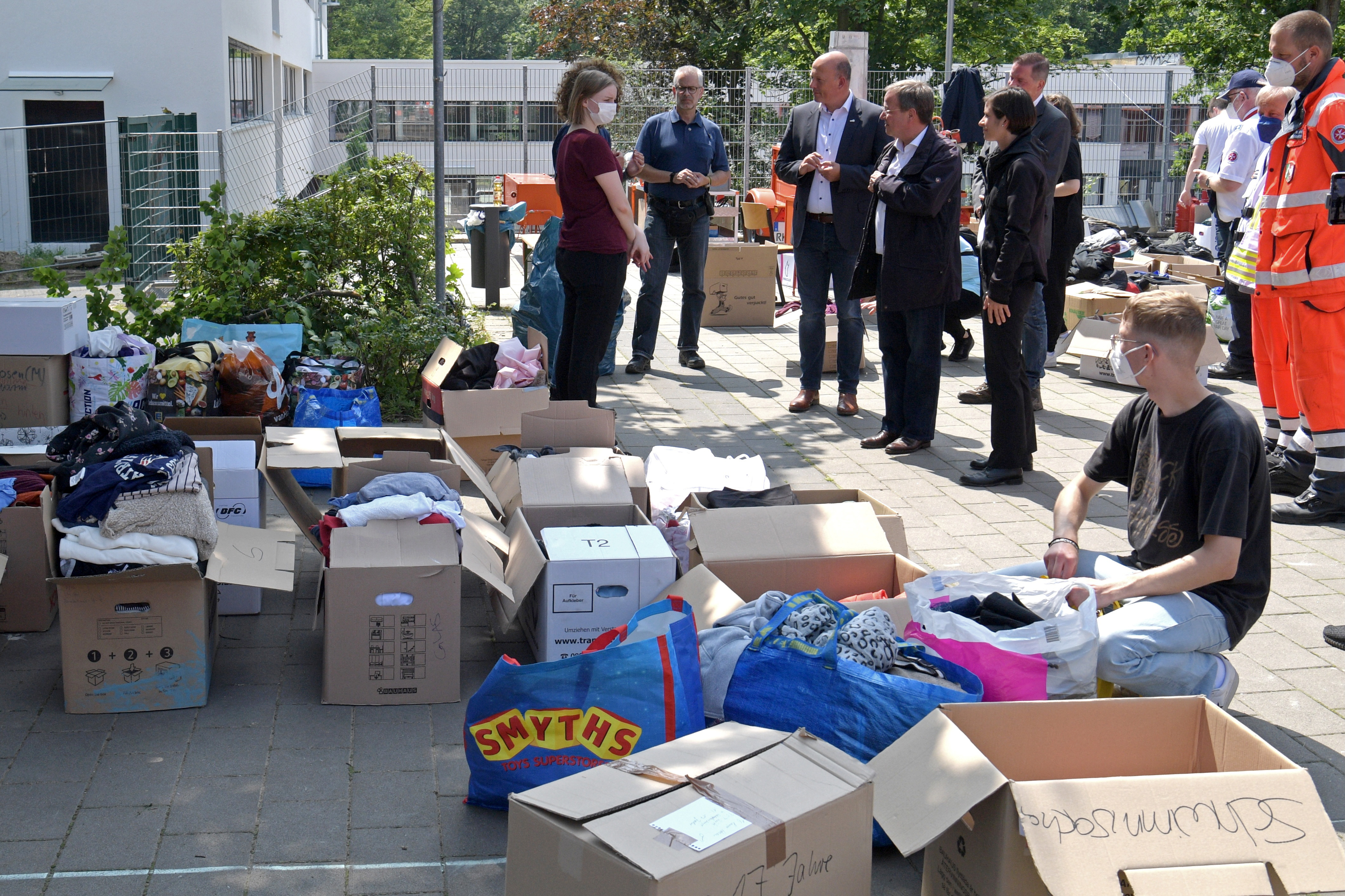 Laschet (4th L) and Mayor Carolin Weitzel (5th L) visit the emergency accommodations in Erftstadt
