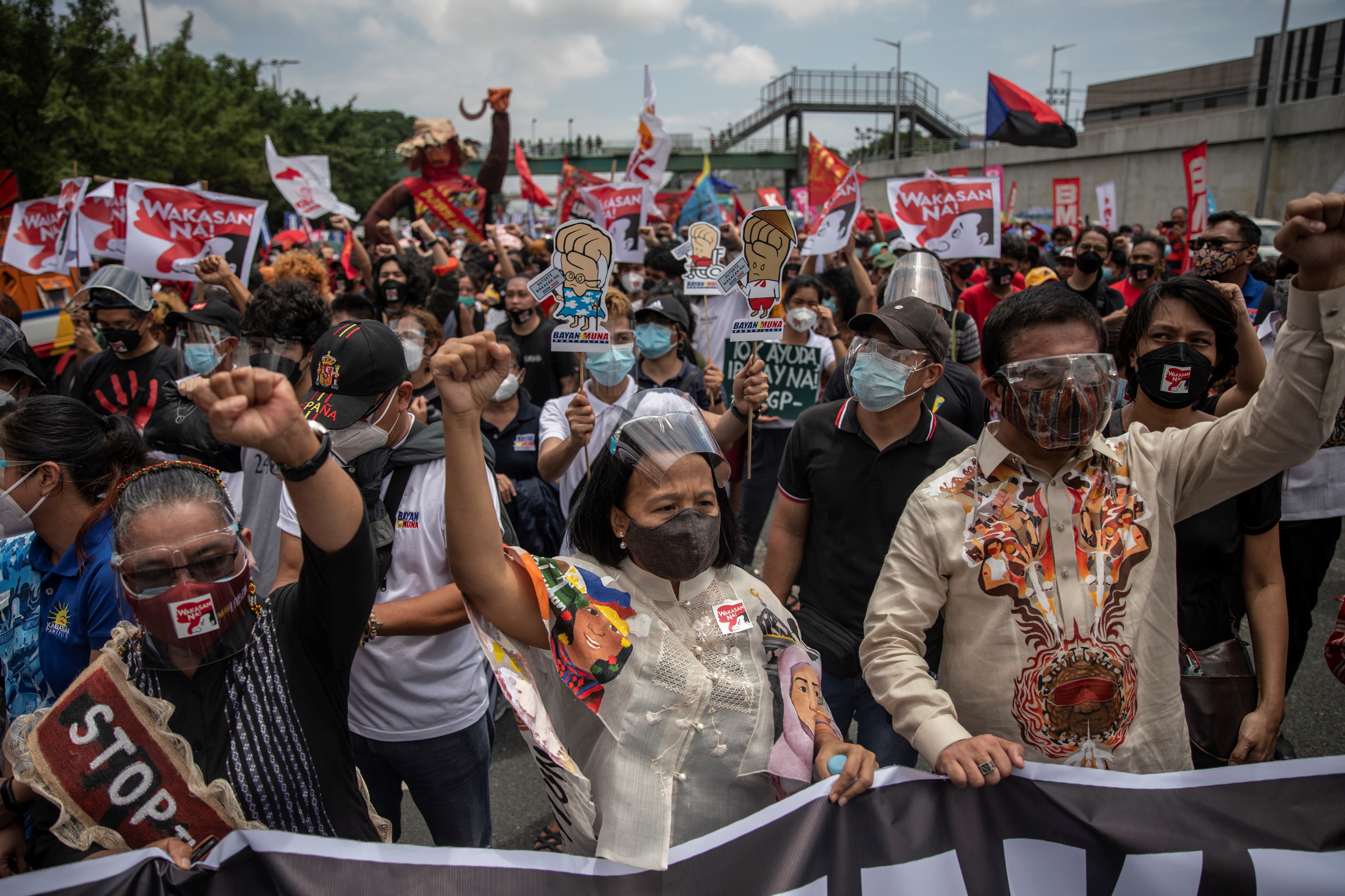 Congressmen raise their fists and march alongside protesters along Commonwealth Avenue, ahead of Philippine President Rodrigo Duterte’s last annual State of the Nation Address, in Quezon City, Philippines, July 26, 2021.