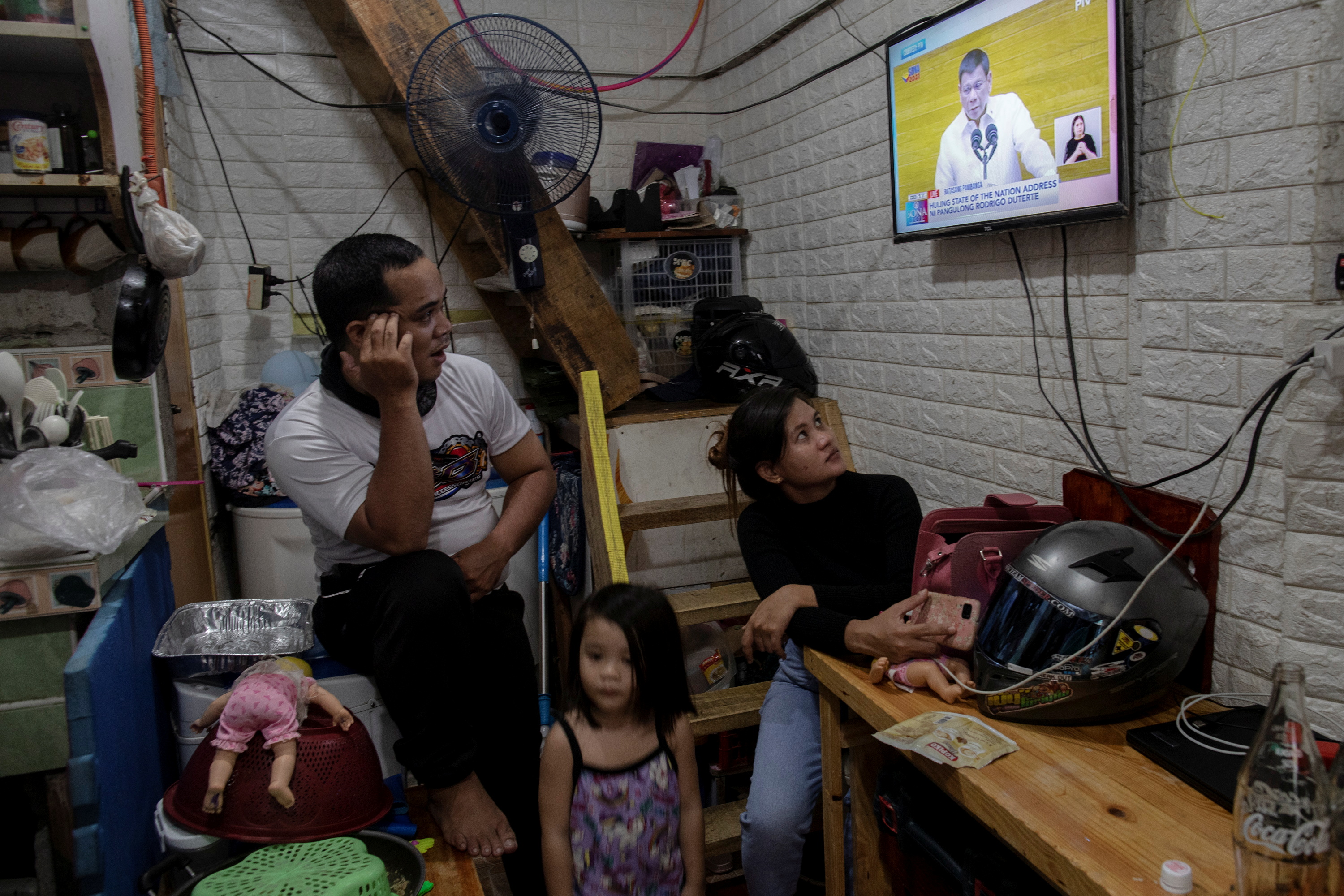 A family watches Philippine President Rodrigo Duterte’s last annual State of the Nation Address in their home in Quezon City, which is part of Metro Manila