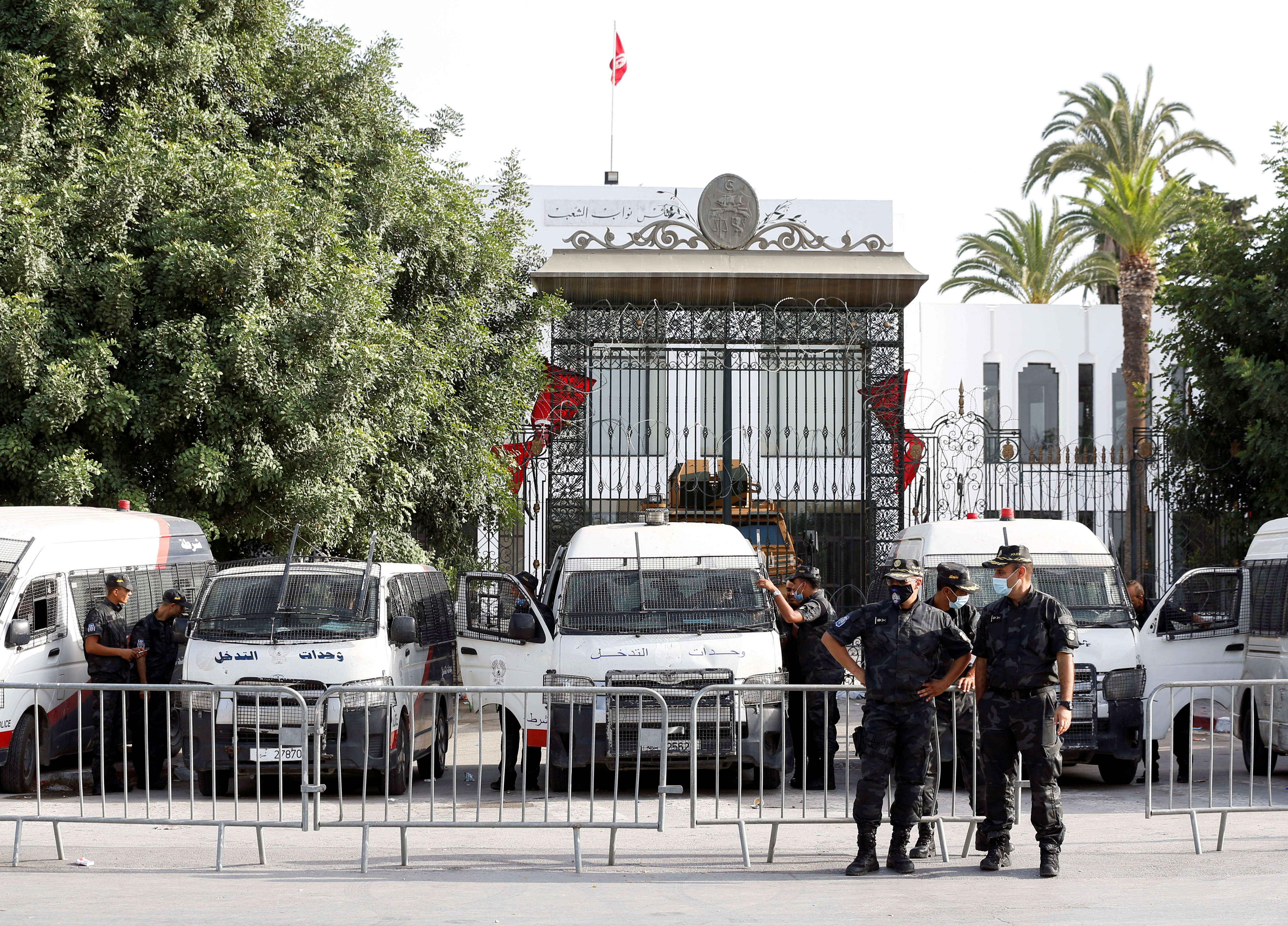Police officers stand guard outside the parliament building in Tunis [Zoubeir Souissi/Reuters]