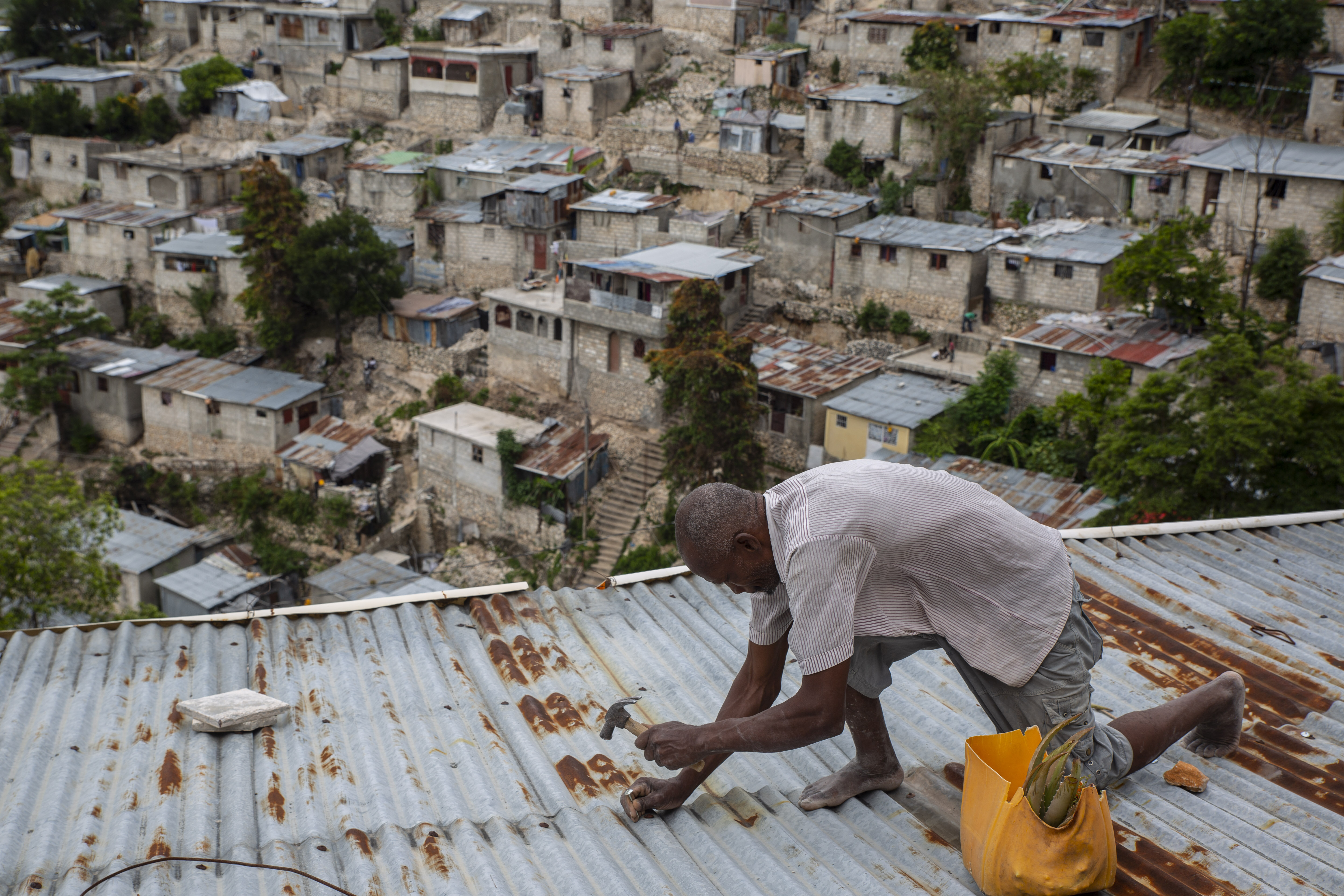 Antony Exilien secures the roof of his house in response to Tropical Storm Elsa, in Port-au-Prince, Haiti, July 3, 2021