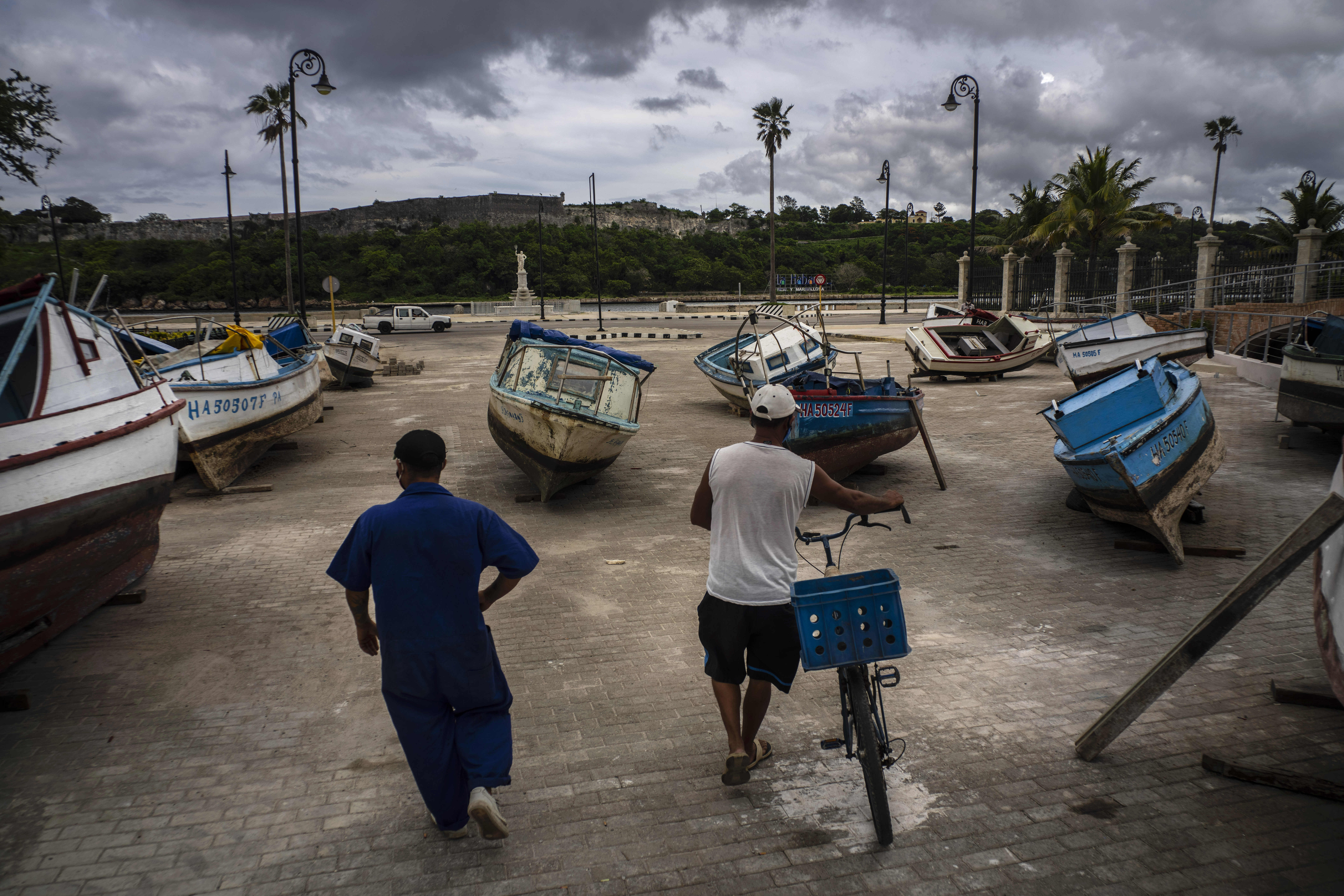 Fishermen inspect their boats after they were taken out of the bay to avoid damage fromTropical Storm Elsa, in Havana, Cuba