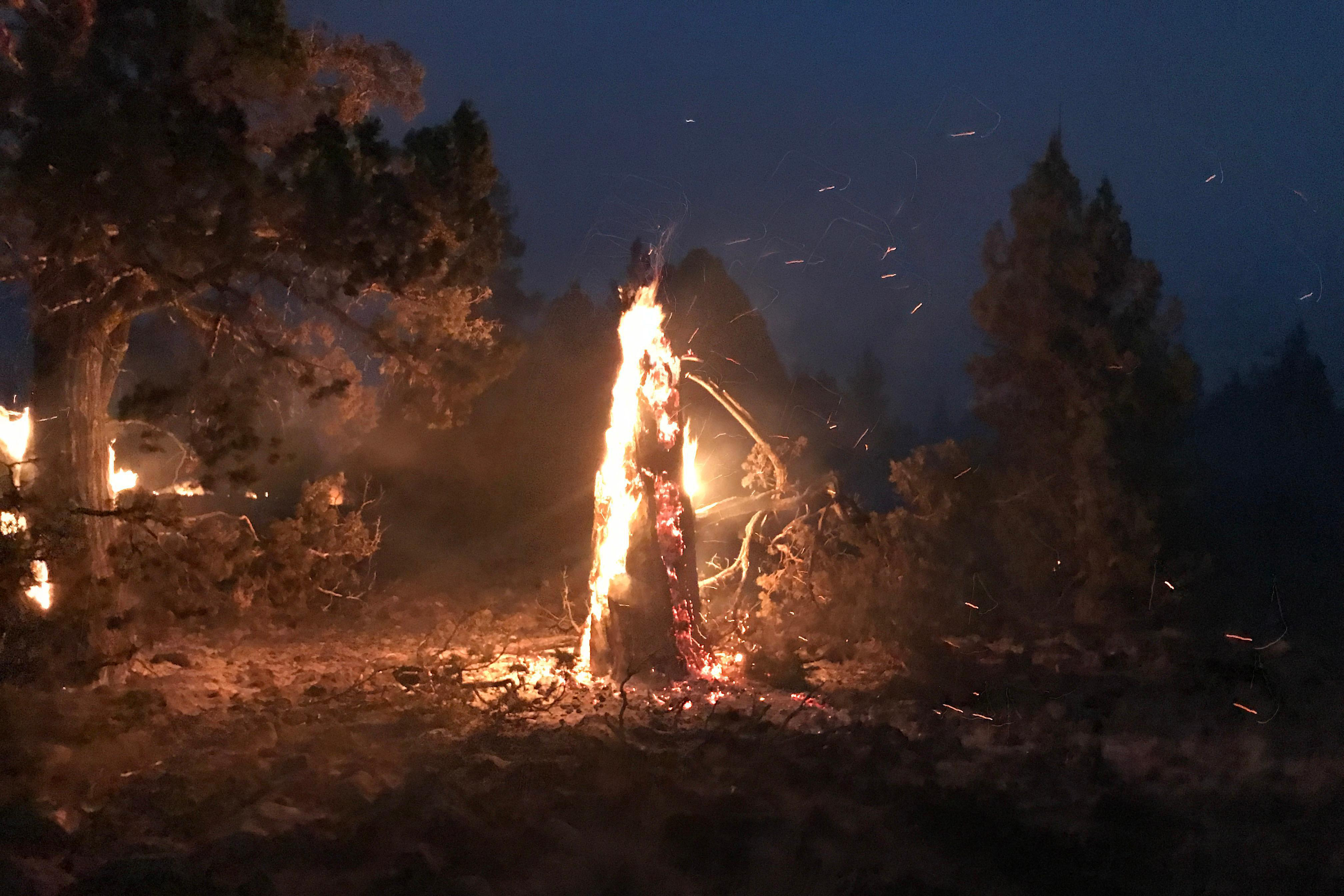 In this photo provided by the Bootleg Fire Incident Command, the Bootleg Fire burns at night near Highway 34 in southern Oregon on Thursday, July 15, 2021