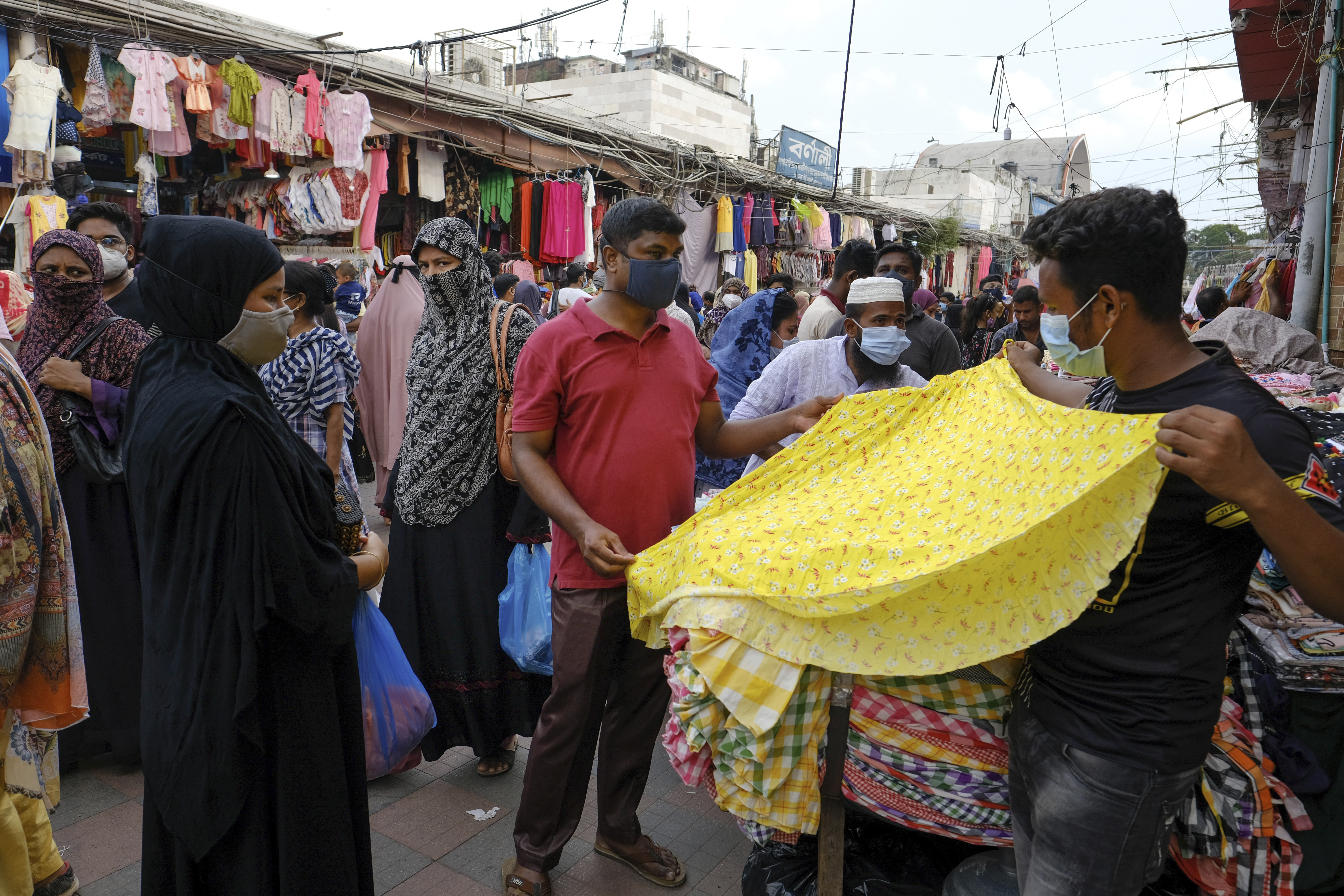 People shop at a market ahead of Eid al-Adha festival in Dhaka