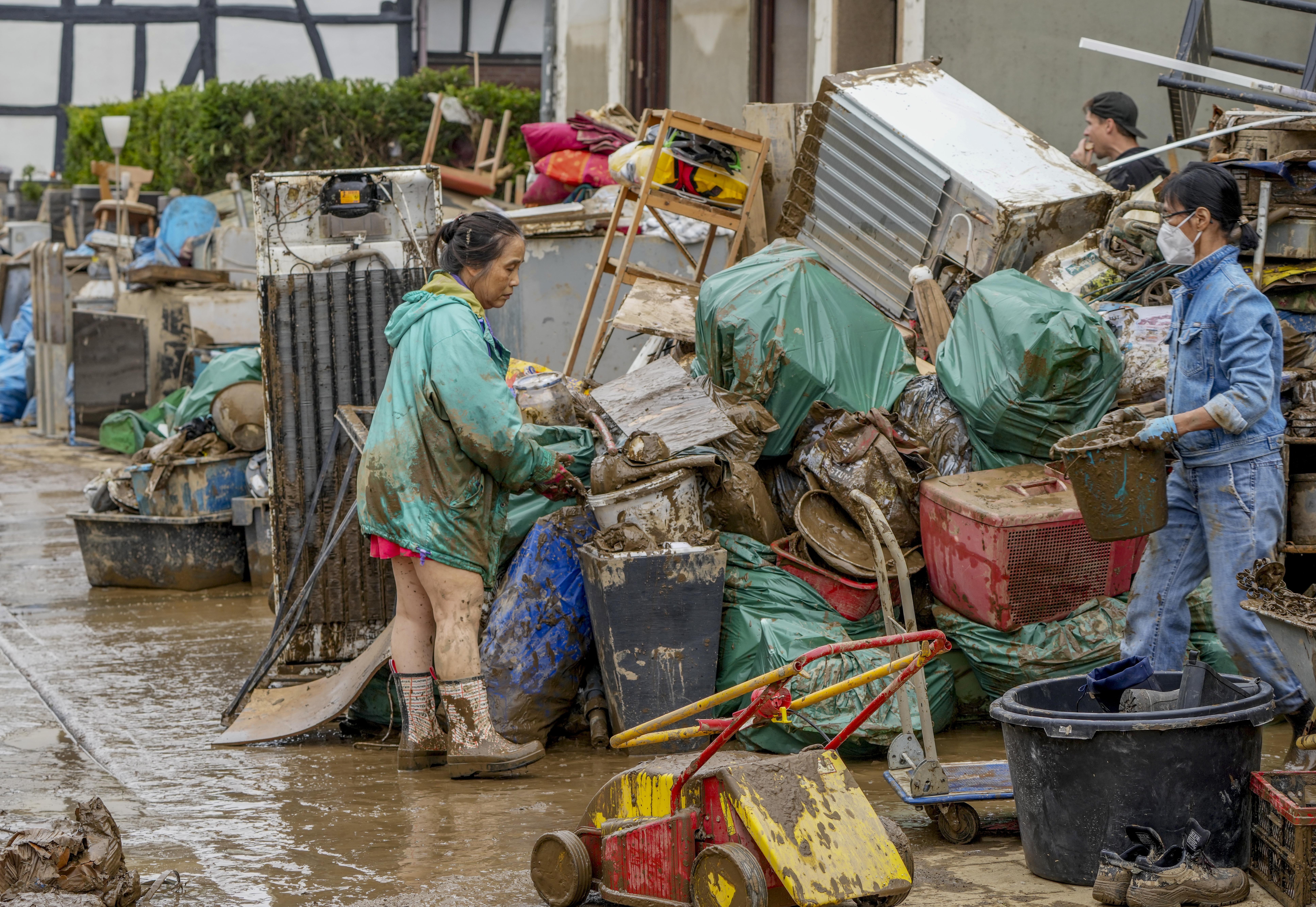 People clean their homes from mud and debris in Bad Neuenahr-Ahrweiler
