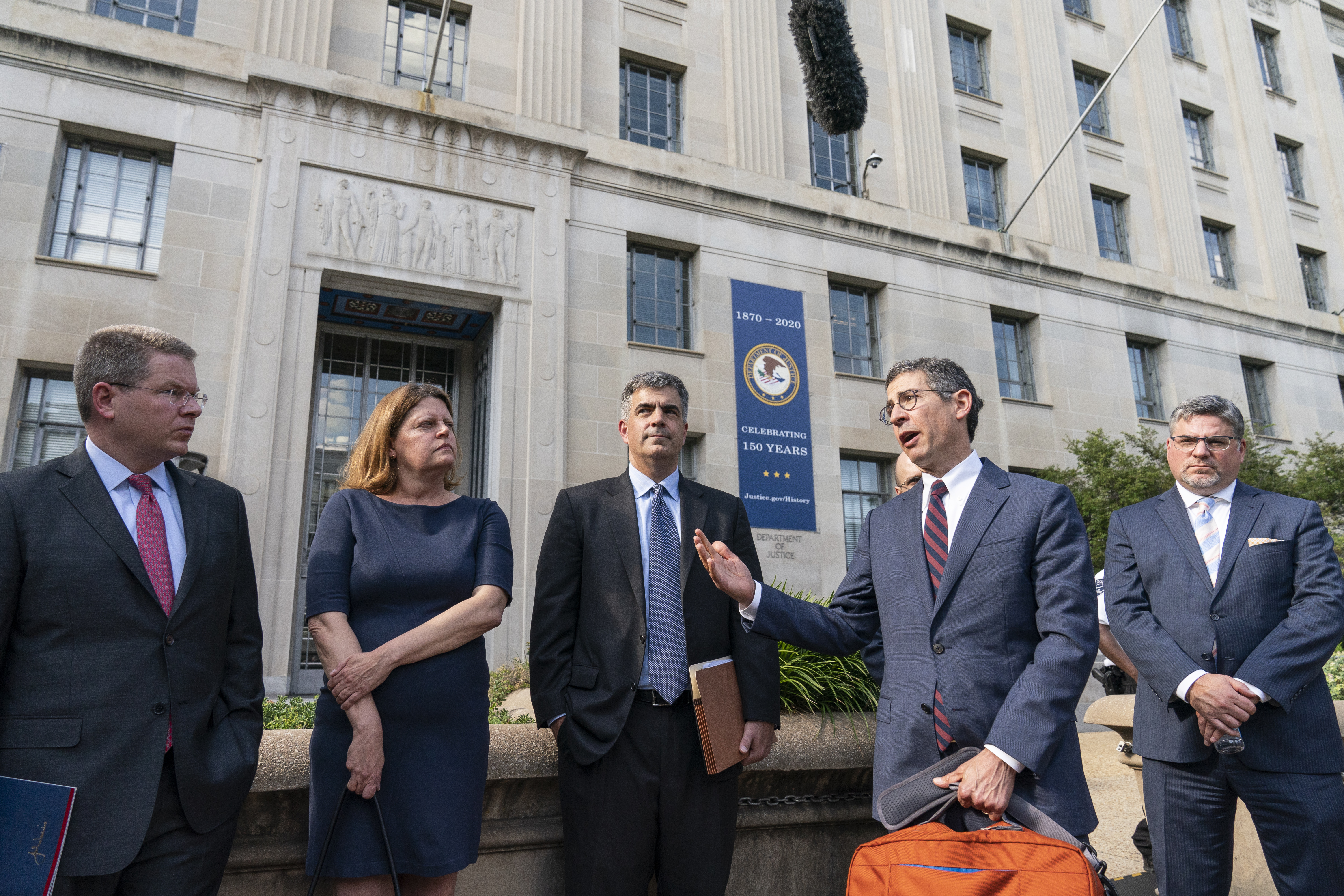 Bruce Brown, second from the right, executive director of the Reporters Committee for Freedom of the Press, accompanied by CNN’s Washington Bureau Chief Sam Feist, left, Washington Post Executive Editor Sally Buzbee, Washington Post General Counsel Jay Kennedy, CNN Executive Vice President and General Counsel David Vigilante, right, after a meeting with Attorney General Merrick Garland at the Department of Justice, in Washington