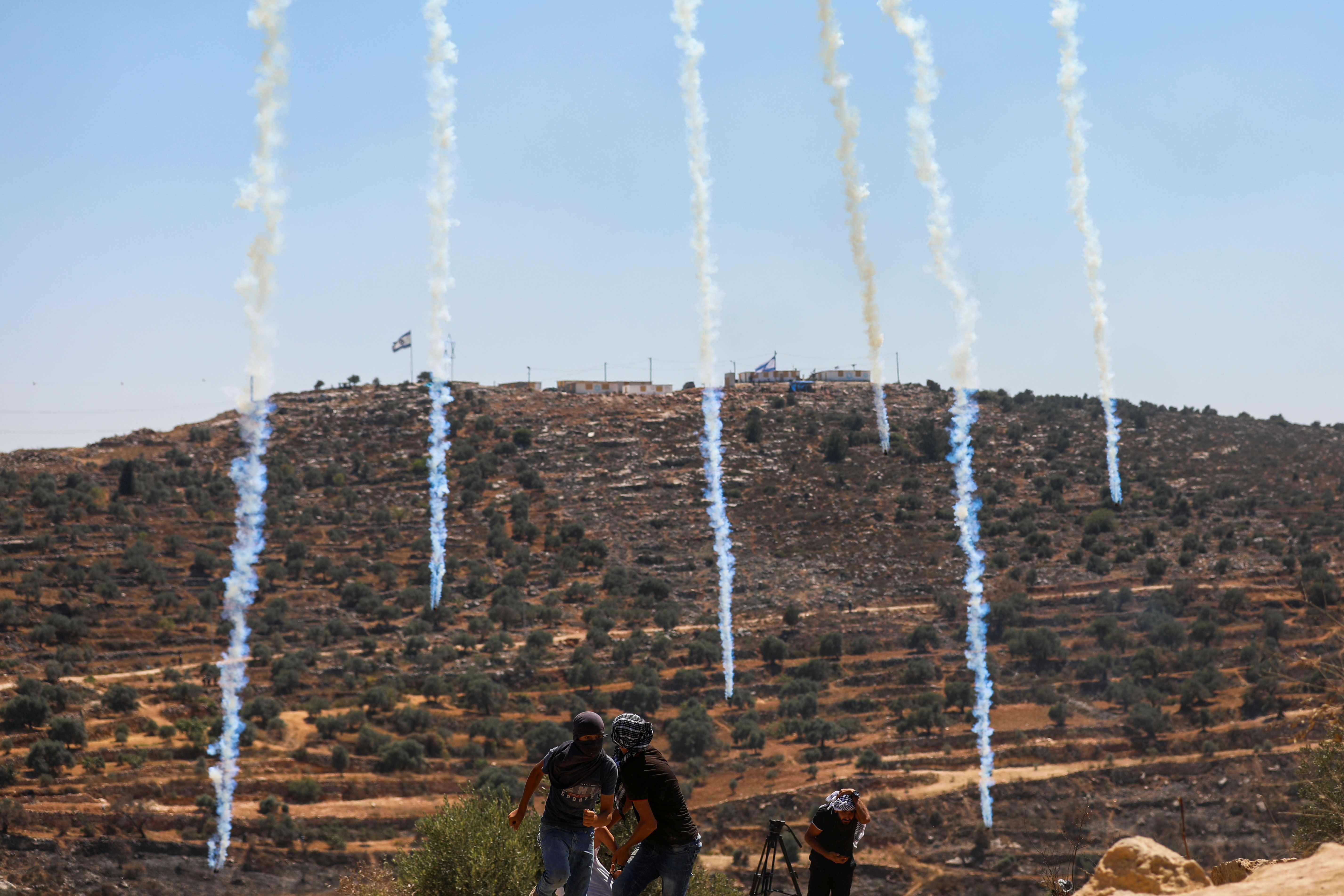 Tear gas canisters are dropped by an Israeli drone to disperse Palestinian demonstrators