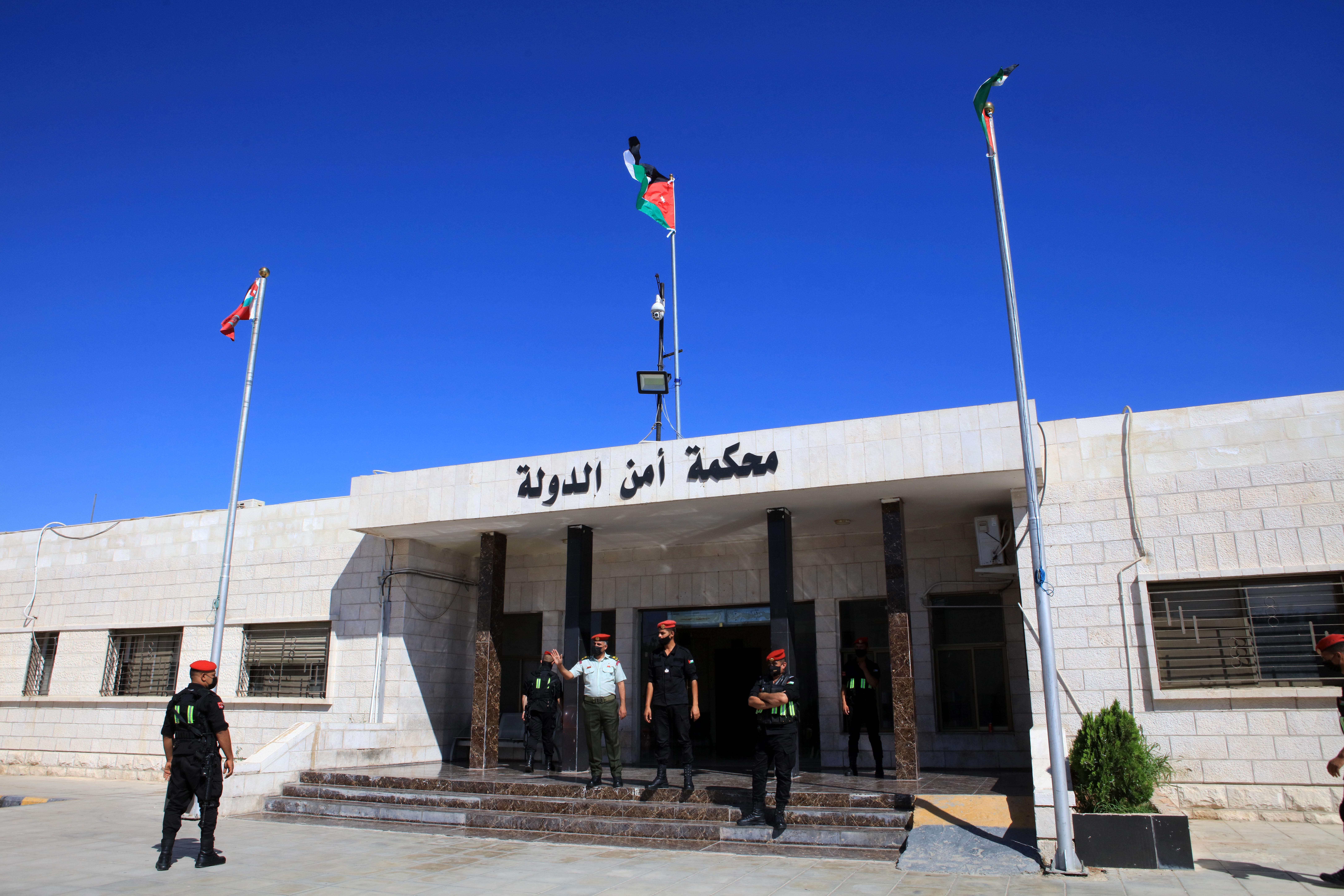 Officers stand guard outside Jordan’s State Security Court, as it was set to announce its verdict in the trial of two officials accused of helping Prince Hamzah try to overthrow his half-brother King Abdullah II, in Amman