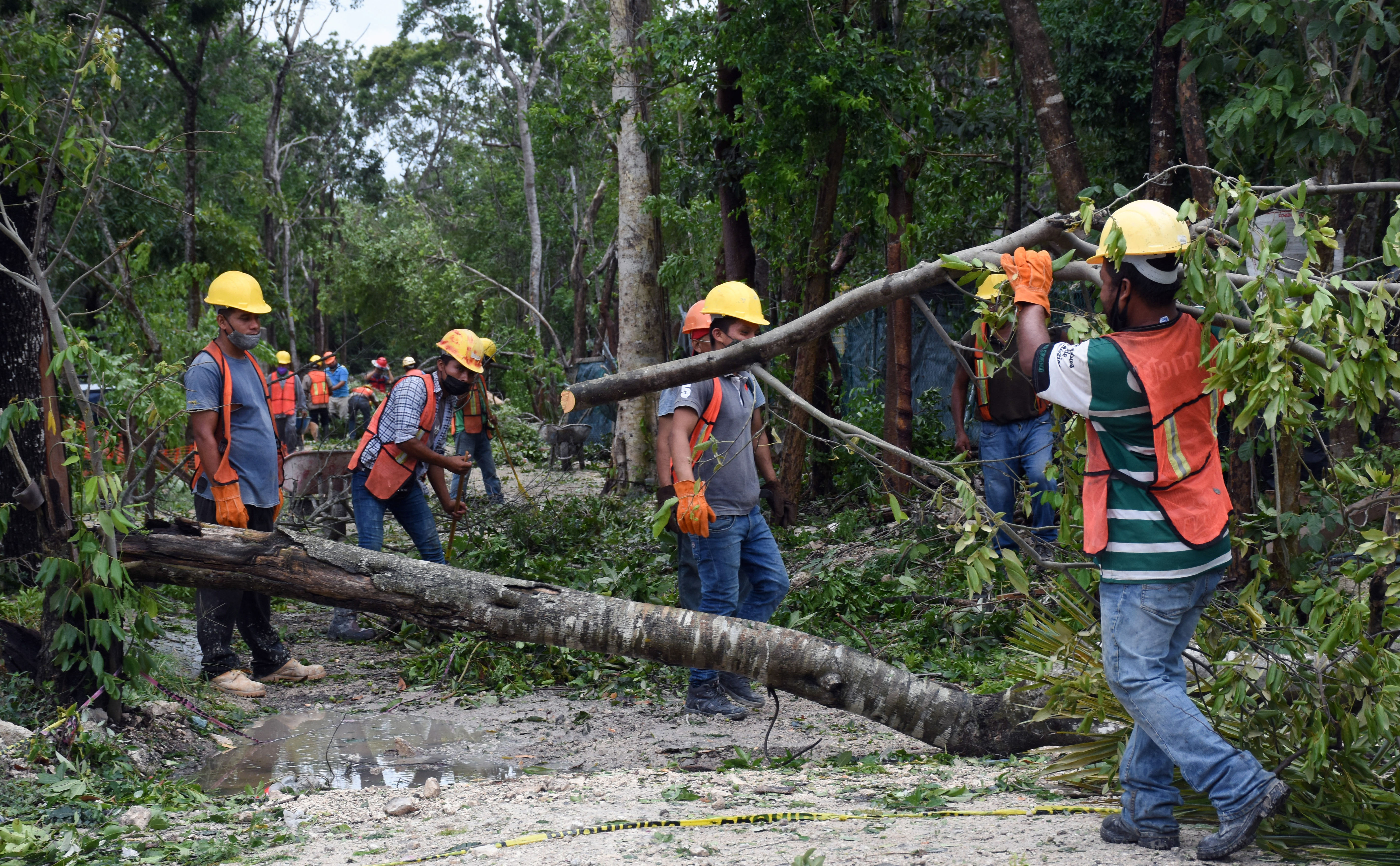 Local workers clean the streets after the passage of Hurricane Grace through the coast of Tulum, state of Quintana Roo, Mexico, on August 19, 2021