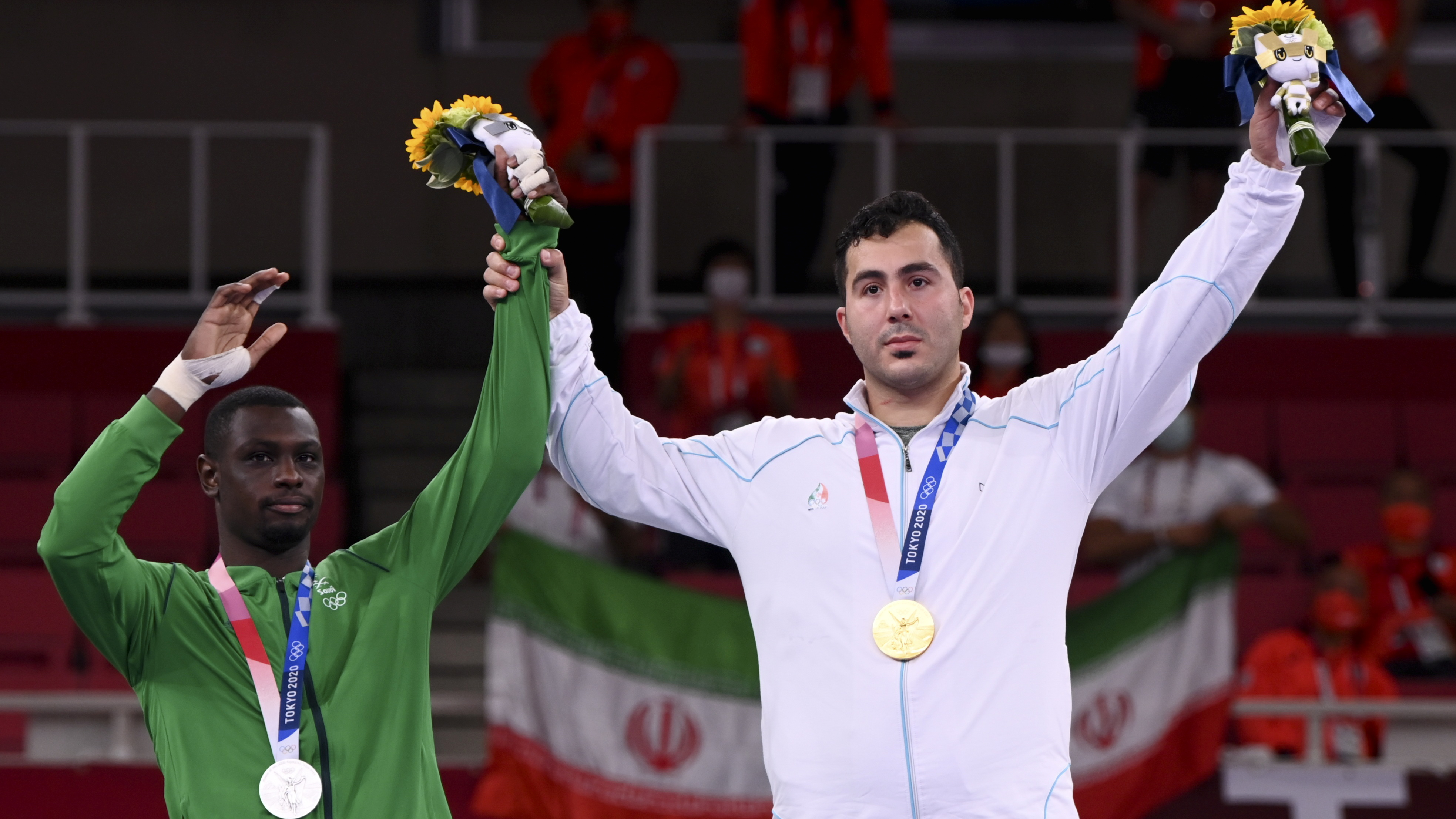 Gold medallist Sajad Ganjzadeh of Iran, right, and silver medallist Tareg Hamedi of Saudi Arabia pose on the podium
