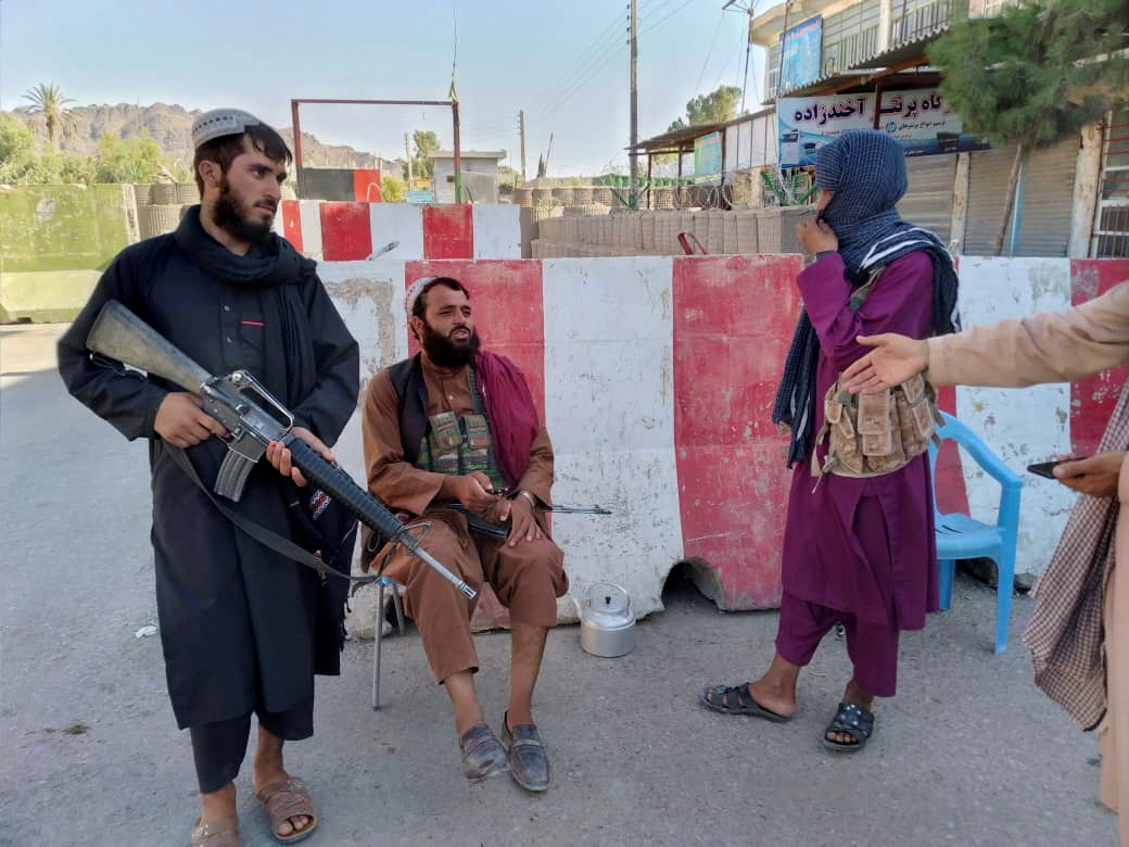 Taliban fighters stand guard at a checkpoint in Farah, Afghanistan August 11, 2021